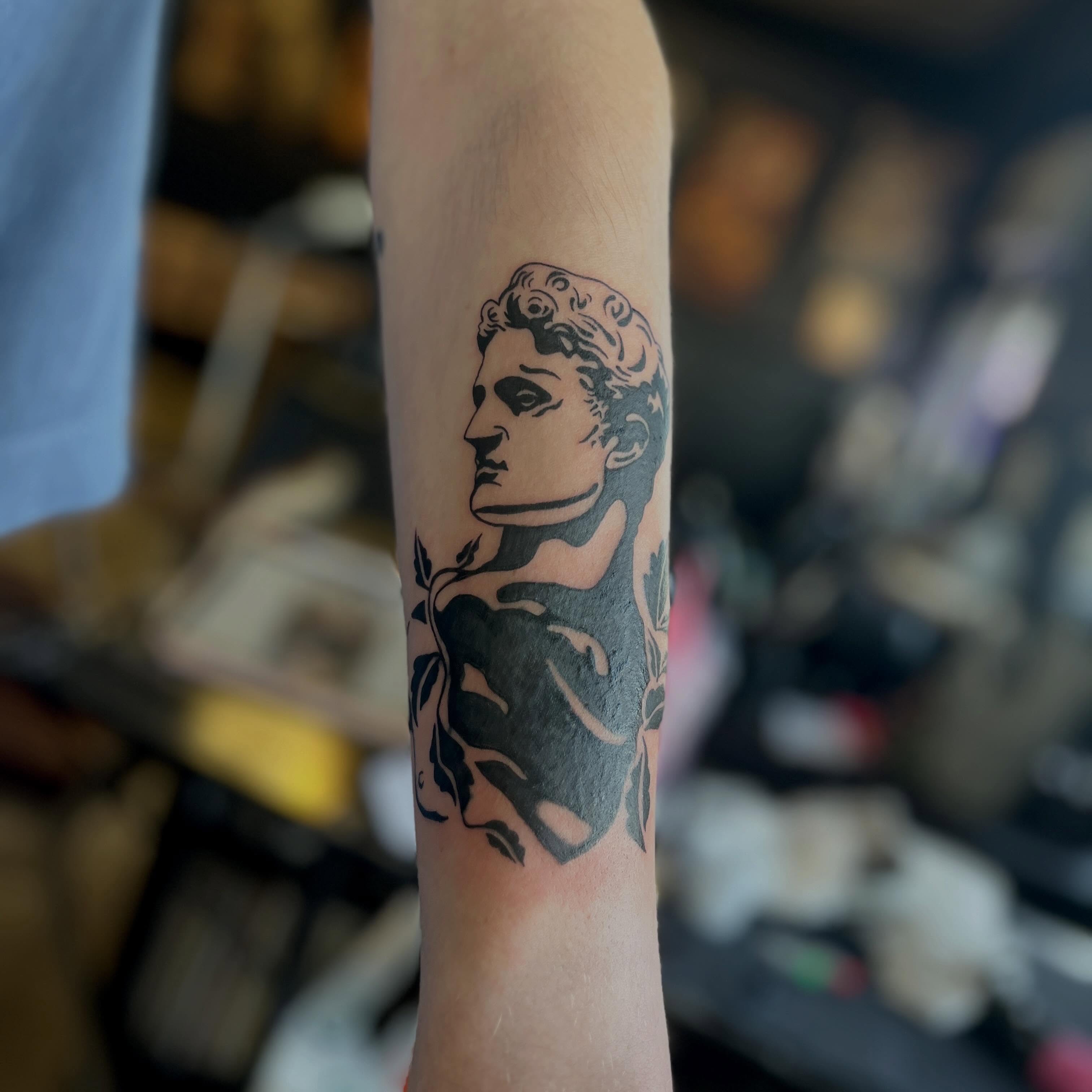 Statue black and grey tattoo on the forearm by sarah