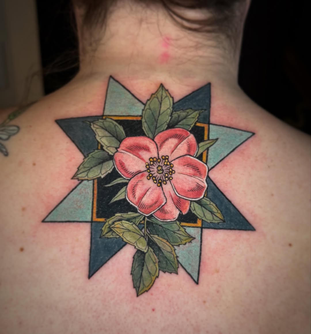 Flower geometric tattoo on the back by Katy Bisby