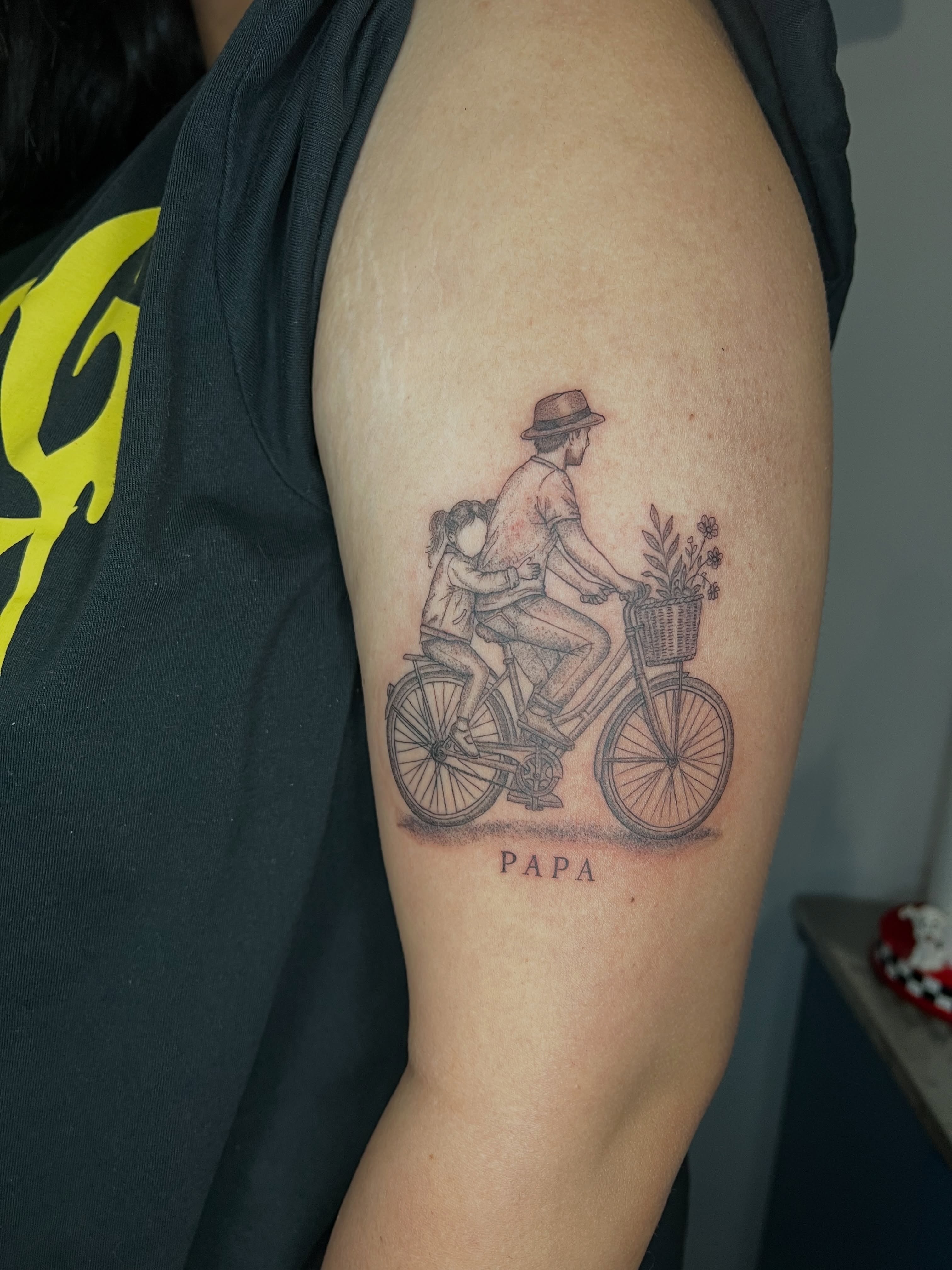Father and child on bicycle realism tattoo on the upper arm by ๐ฆ๐๐๐ก ๐ฆ๐๐๐
