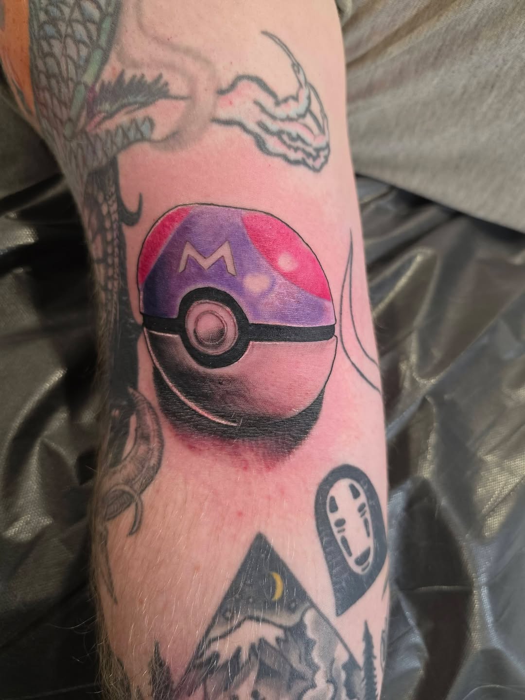 Pokemon Master Ball tattoo on the forearm by komik tattoos
