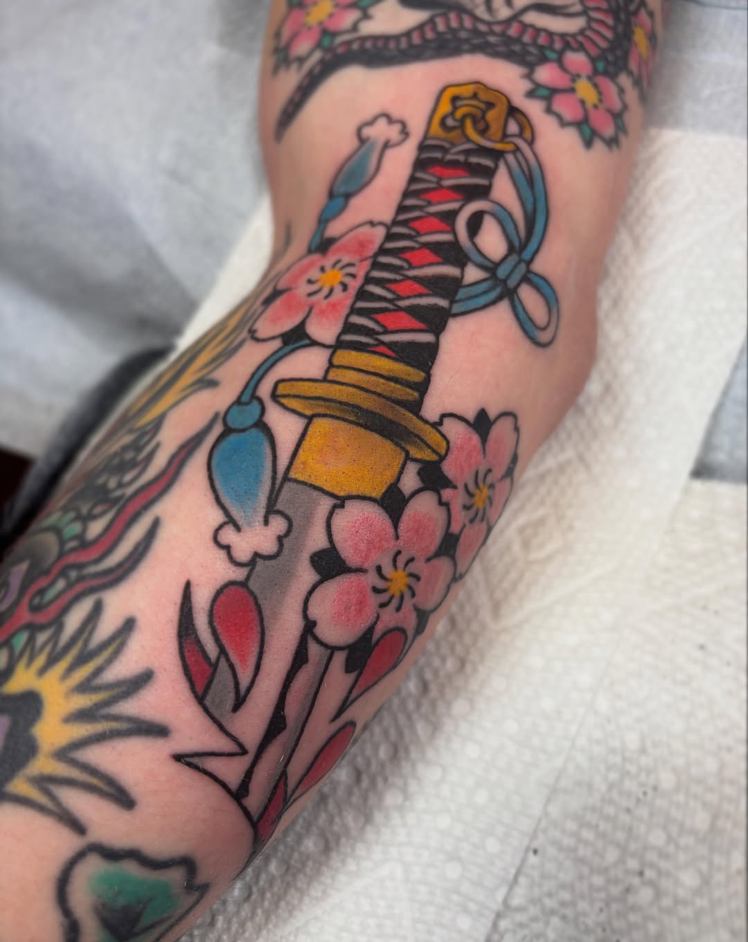 Katana and cherry blossoms American traditional tattoo on the forearm by dayton skuse, Portland, Oregon