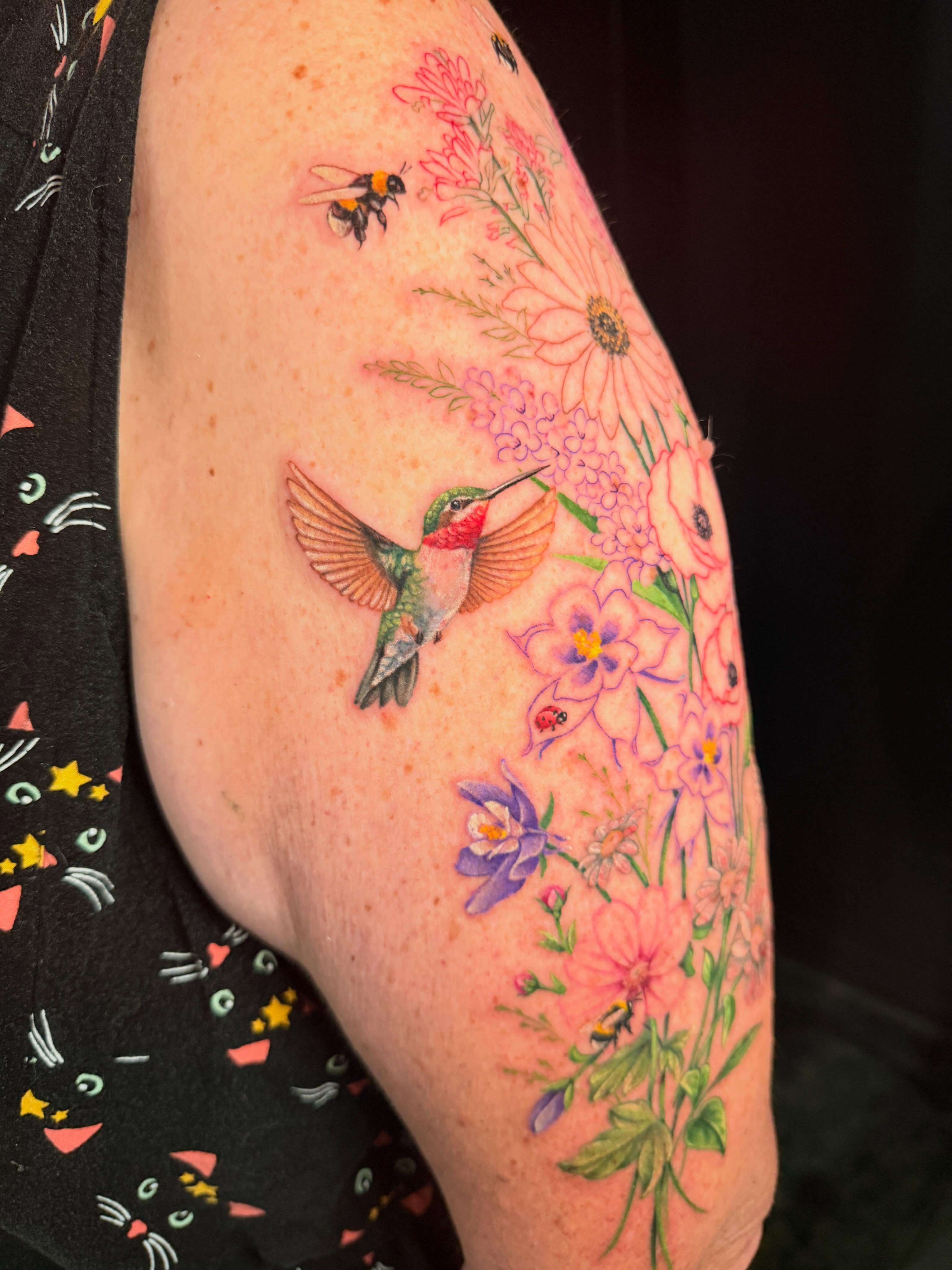 Hummingbird and floral bouquet new school tattoo on the forearm by Violet Michelle Williams, Charlotte, North Carolina