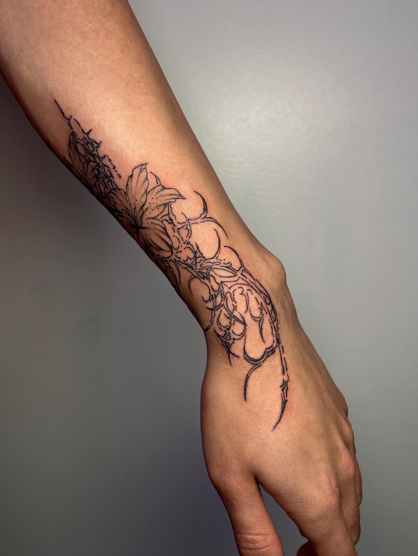 Floral design black and grey tattoo on the forearm by MK