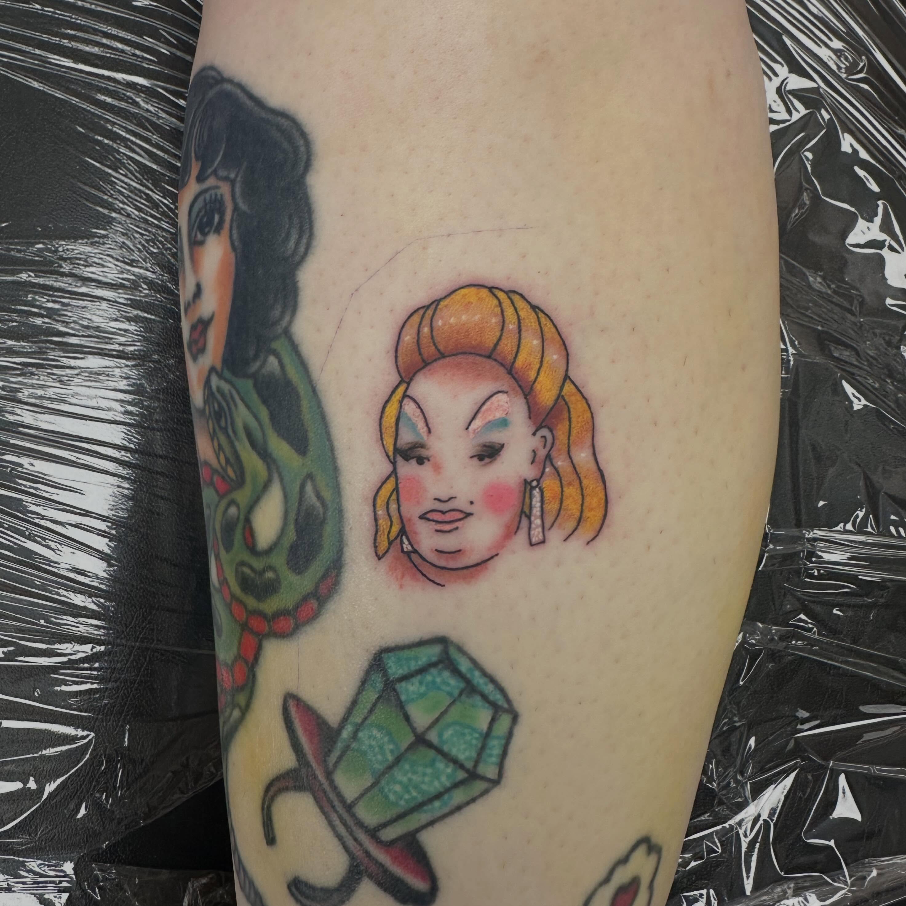 Woman with braided hair American traditional tattoo on the forearm by Nicki Hoverson