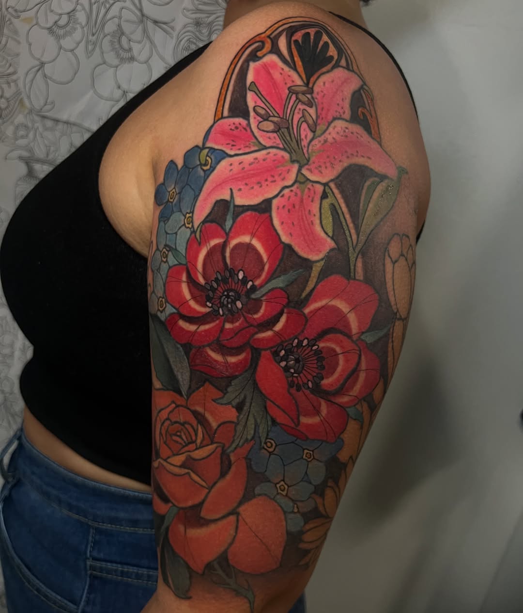 Floral bouquet new school tattoo on the upper arm by Rennie Tattoo