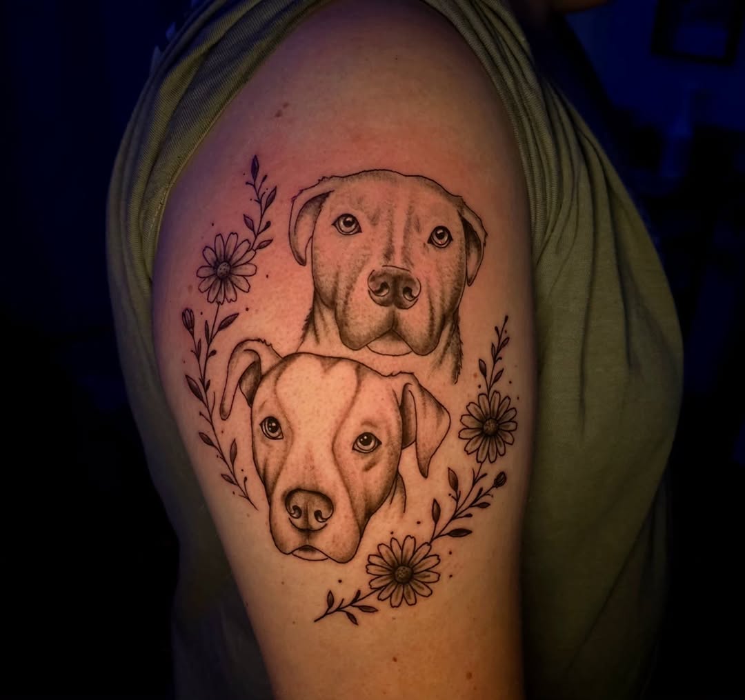 Two pitbull dogs with flowers realism tattoo on the shoulder by Karley Michelle Moody
