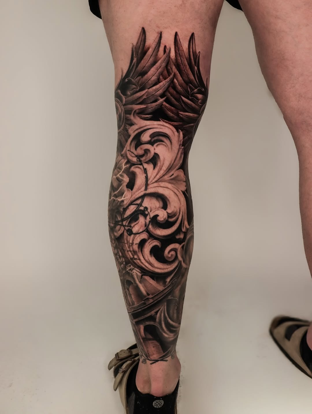 Ornamental filigree and wings realism tattoo on the forearm by Jeff Reindel