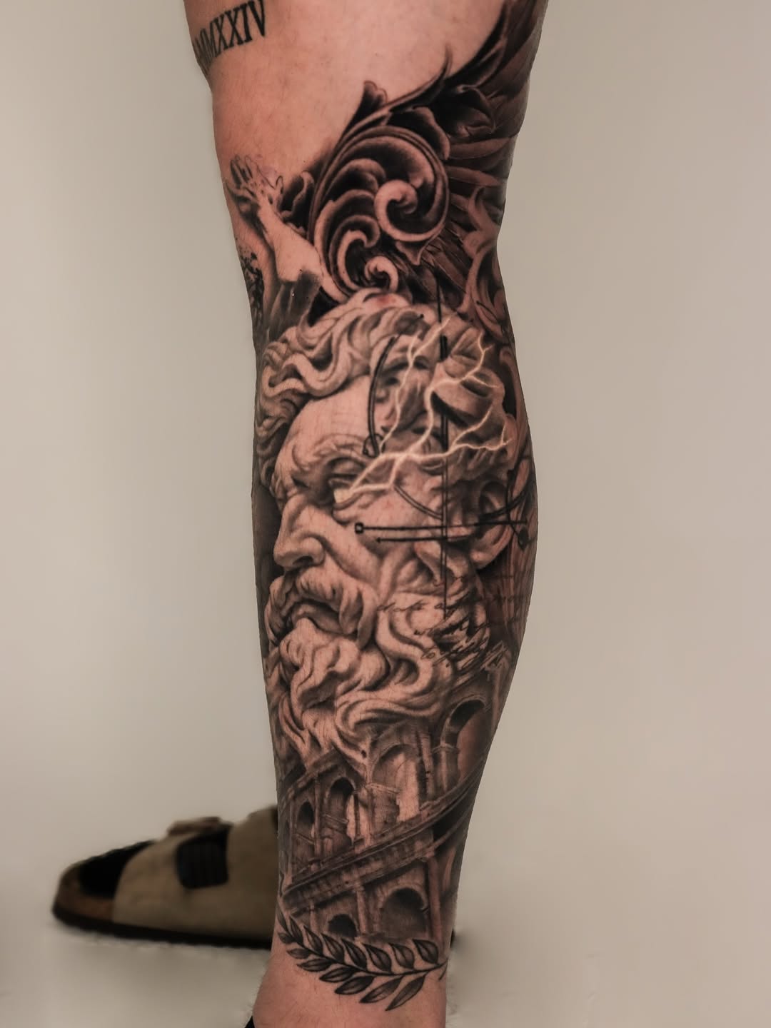 Bust of Zeus and Roman architecture Japanese tattoo on the calf by Jeff Reindel