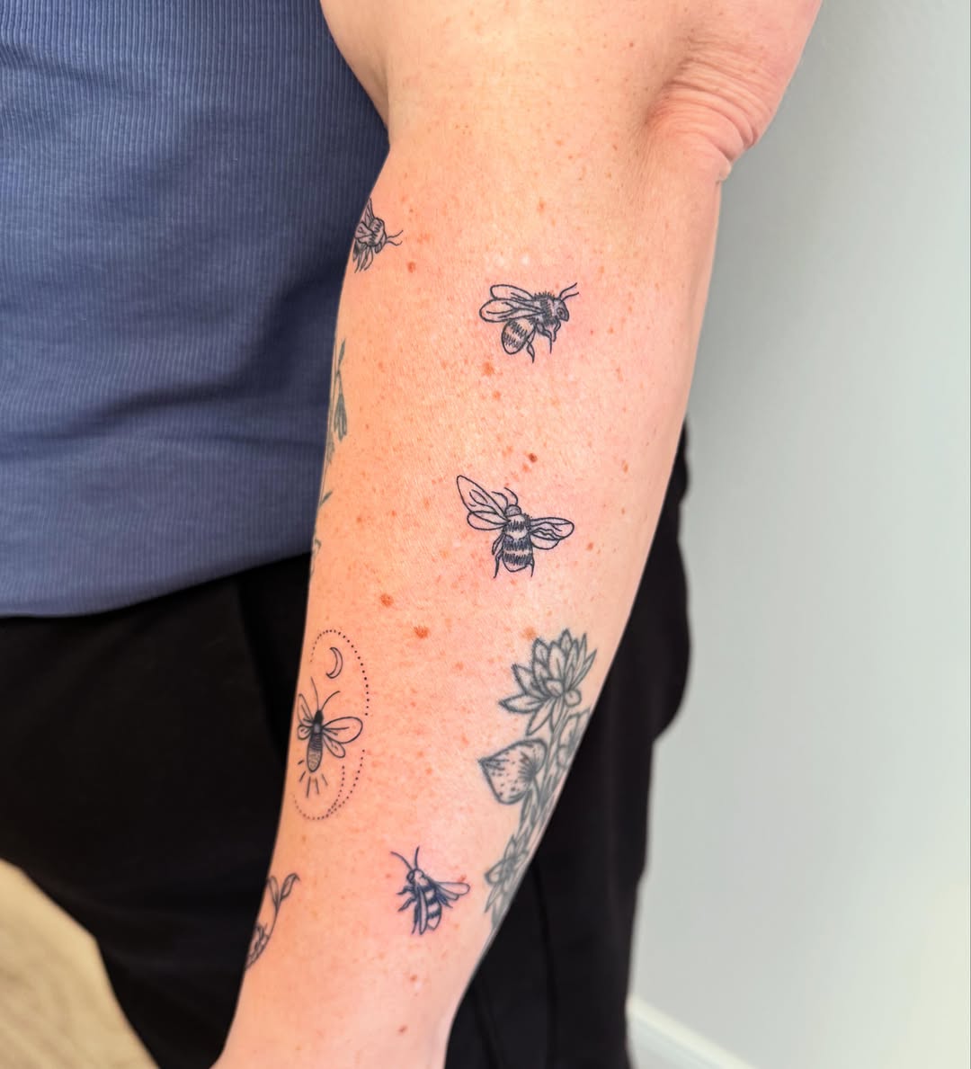Bees and flowers dotwork tattoo on the forearm by Angela Nery, South Jordan, Utah