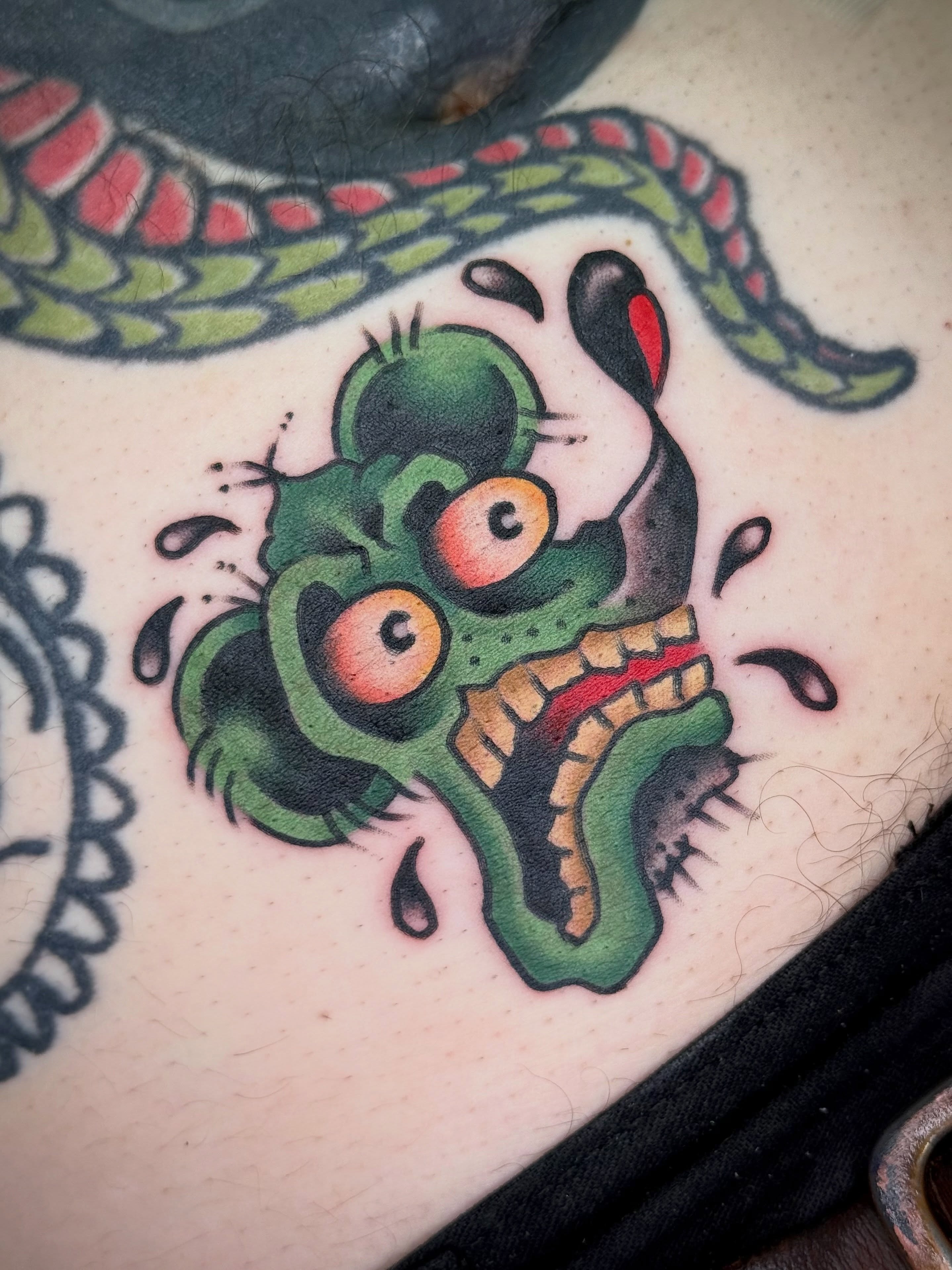 Green monster American traditional tattoo on the torso by Maximilian Harrison