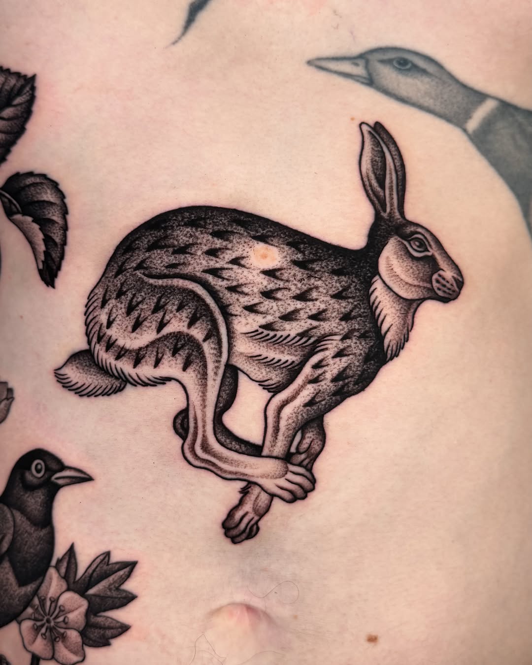 Hare black and grey tattoo on the chest by Jae Traditional Tattoo