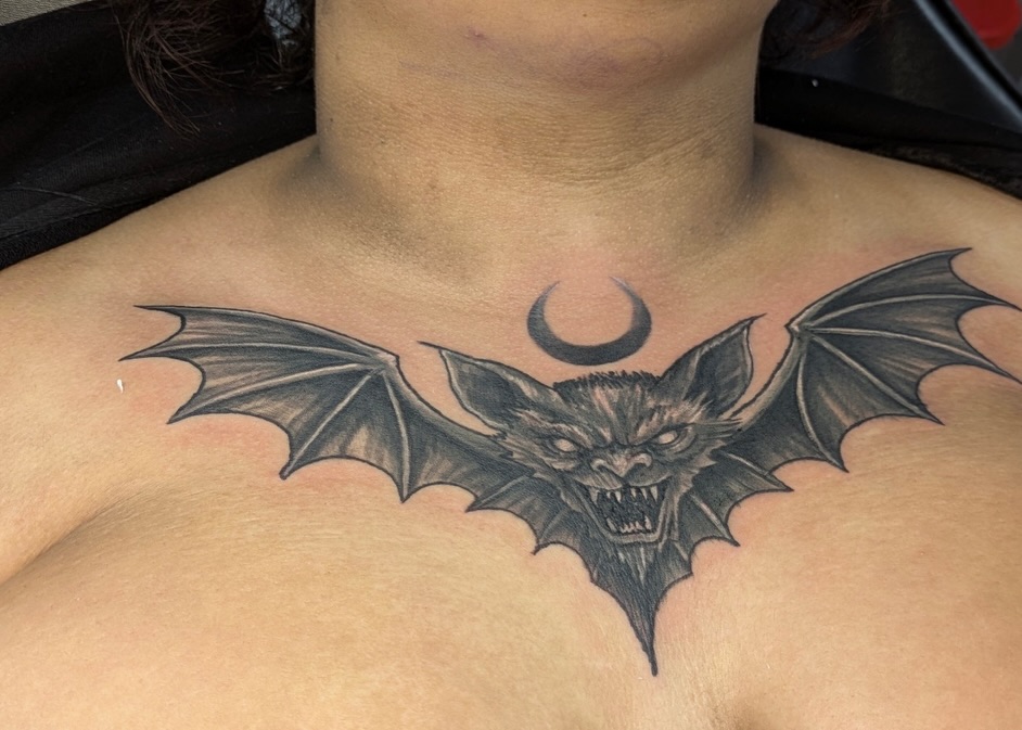Bat black and grey tattoo on the chest by Buddy K.