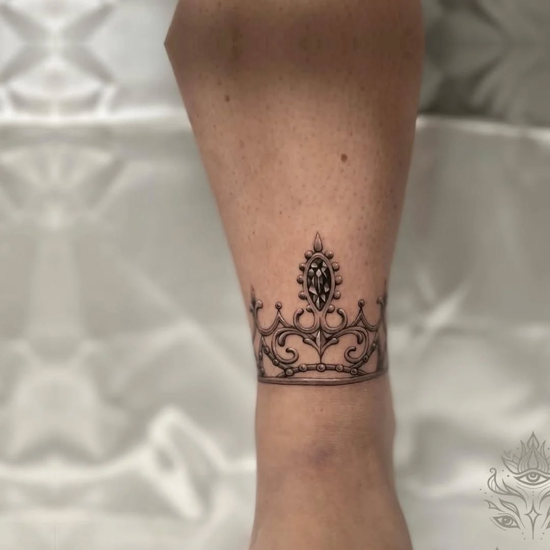 Crown ornamental tattoo on the forearm by Nils Bashirian