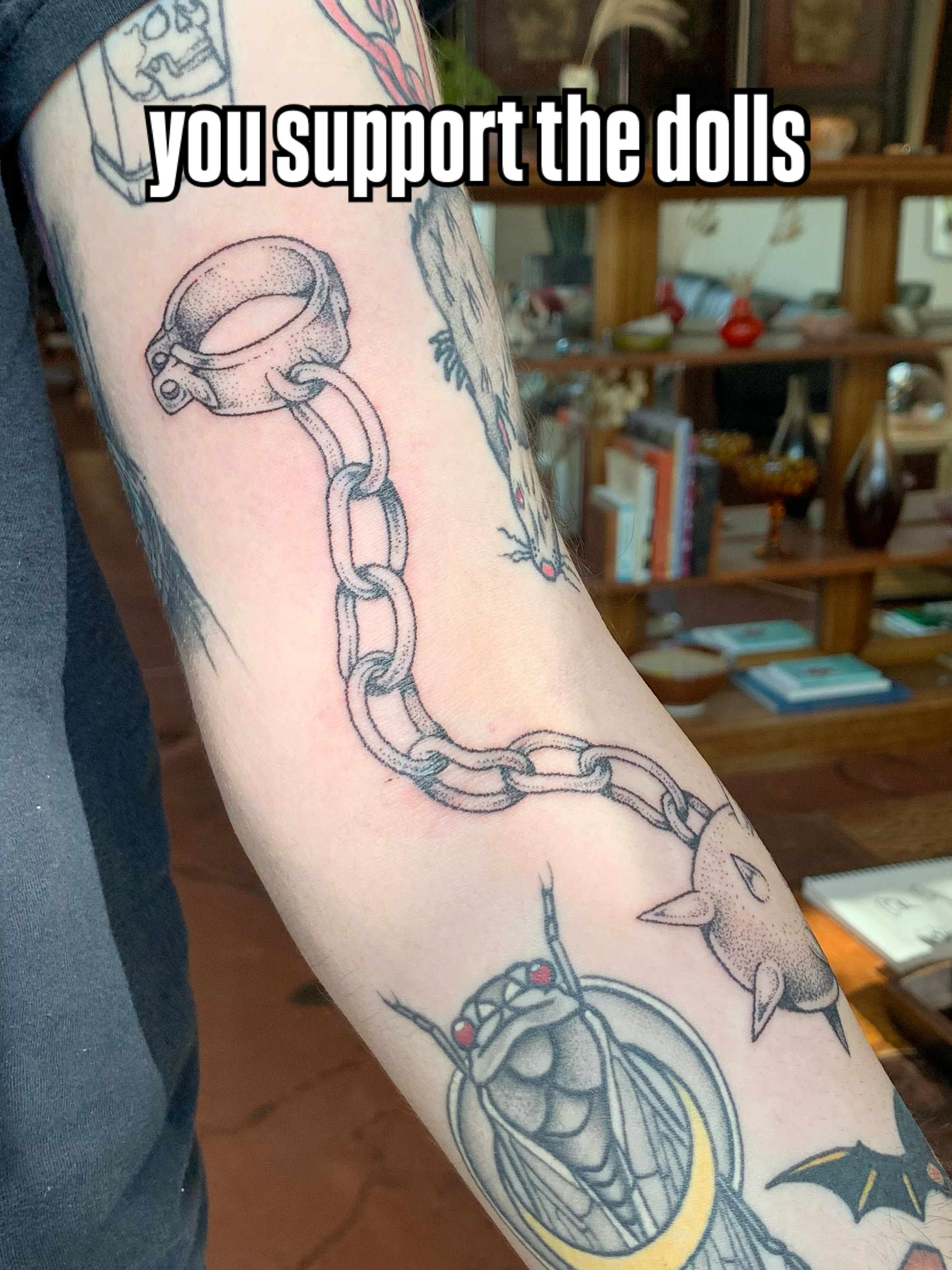 Chain and handcuff dotwork tattoo on the forearm by Lex Lloyd