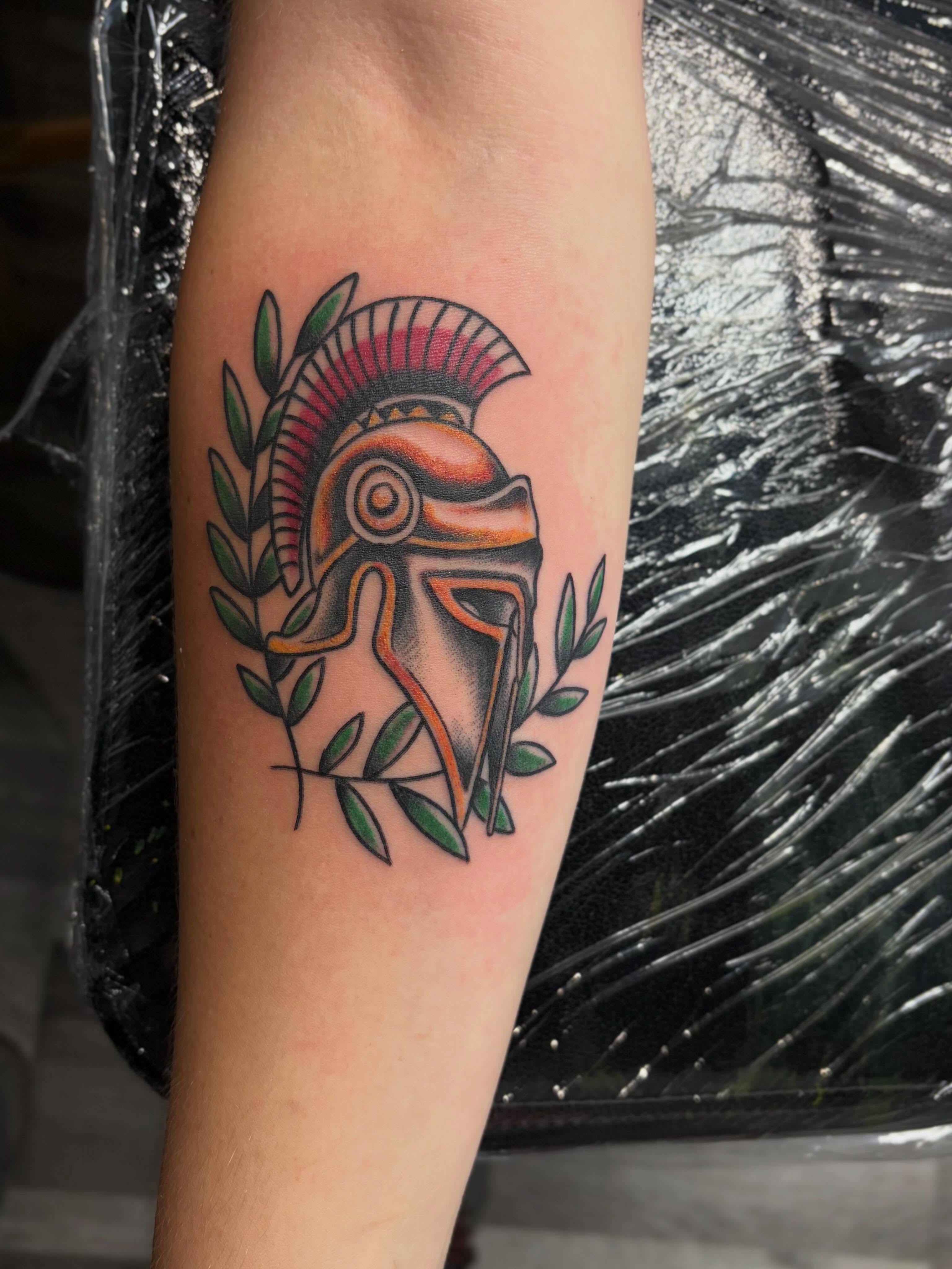 Spartan helmet American traditional tattoo on the forearm by @rayscott_tattoo