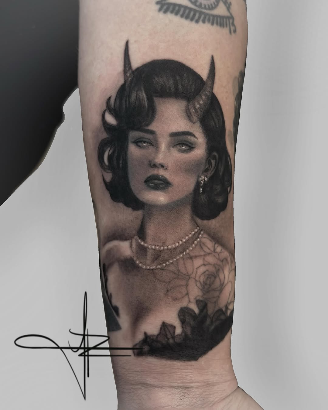 Woman with horns and pearls realism tattoo on the forearm by Jazz