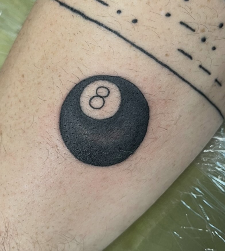 8-ball black and grey tattoo on the forearm by Brianna Jo Ballinghoff