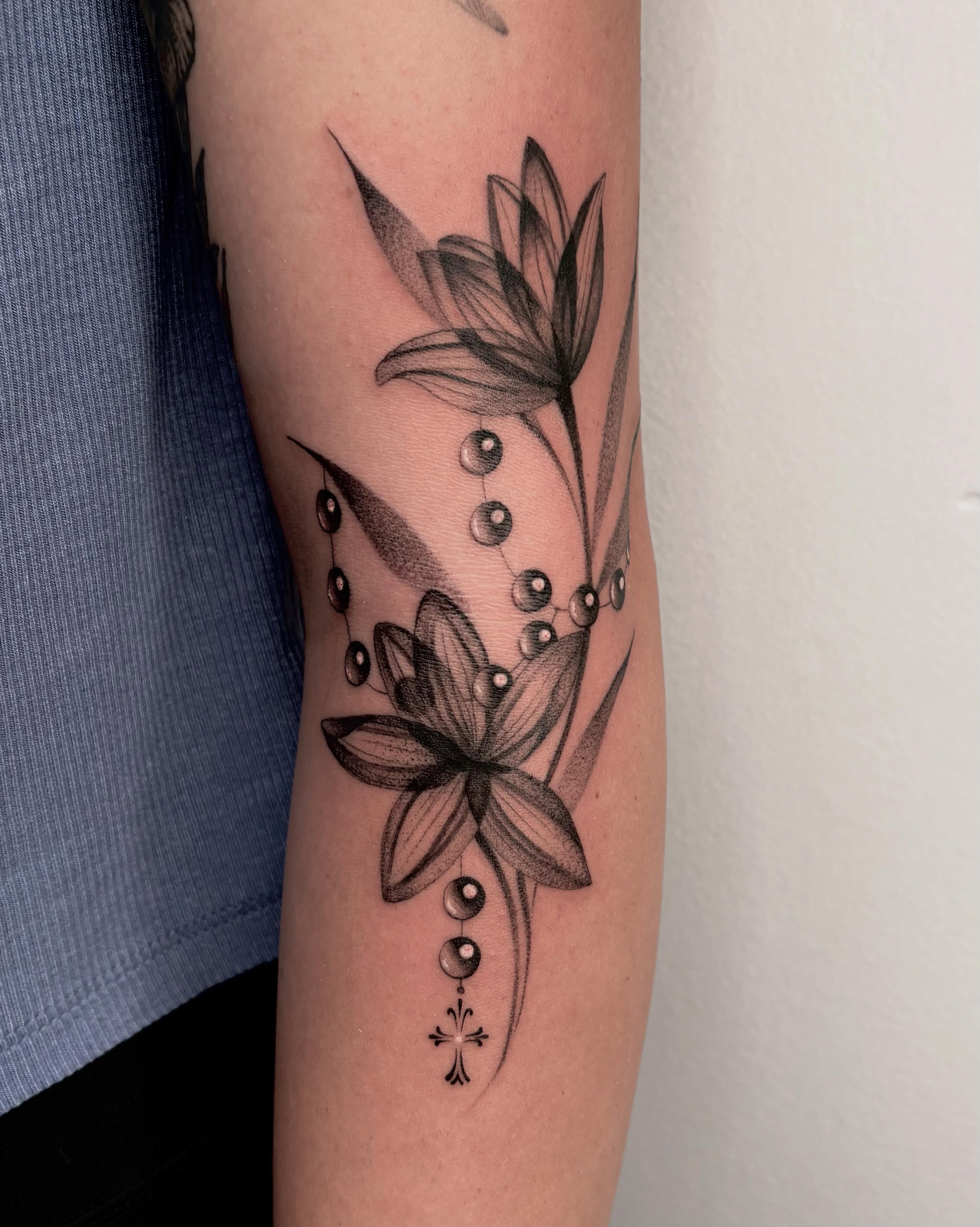 Floral arrangement dotwork tattoo on the forearm by Avery Mullins