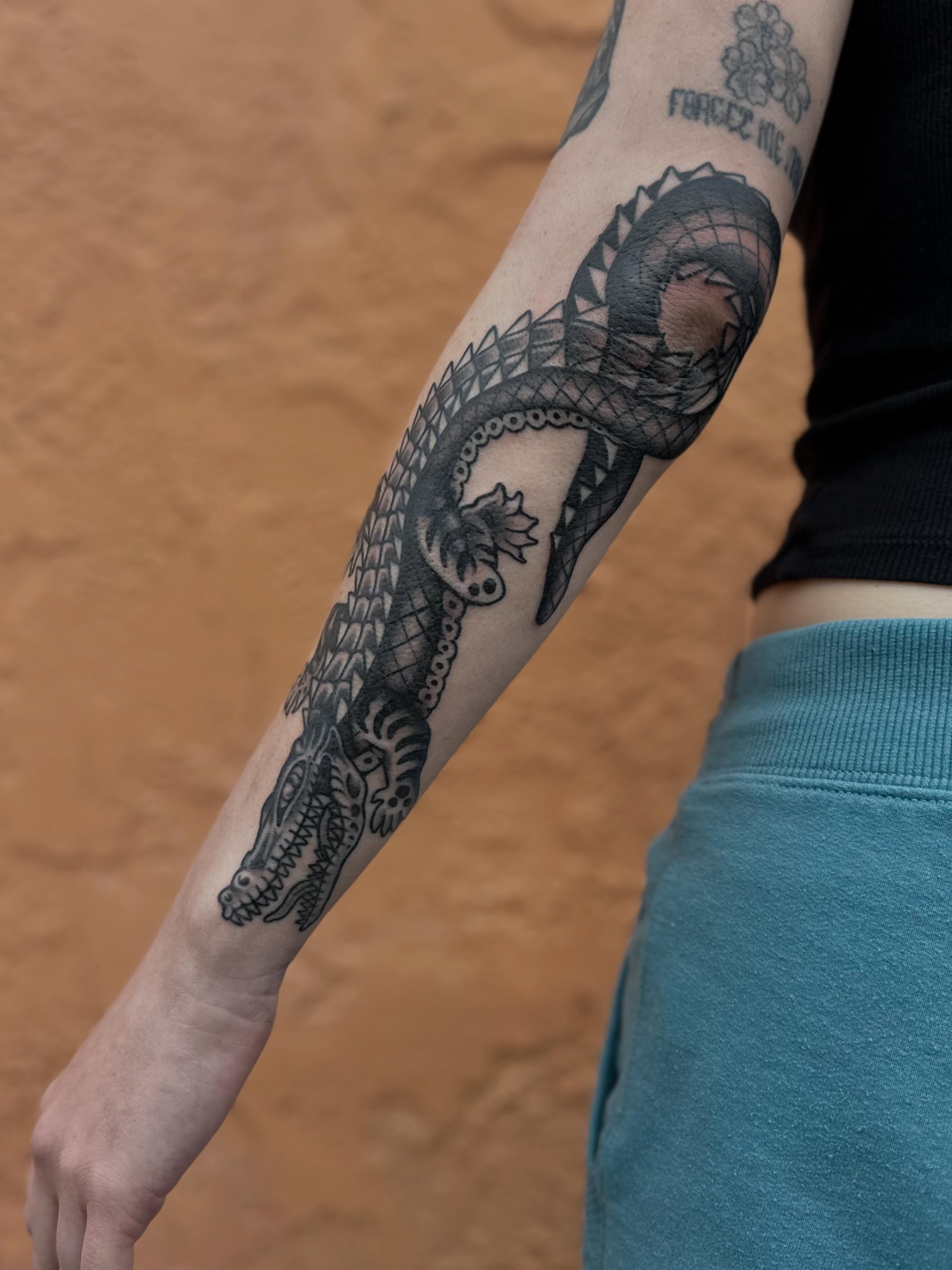 Alligator black and grey tattoo on the forearm by mia palau