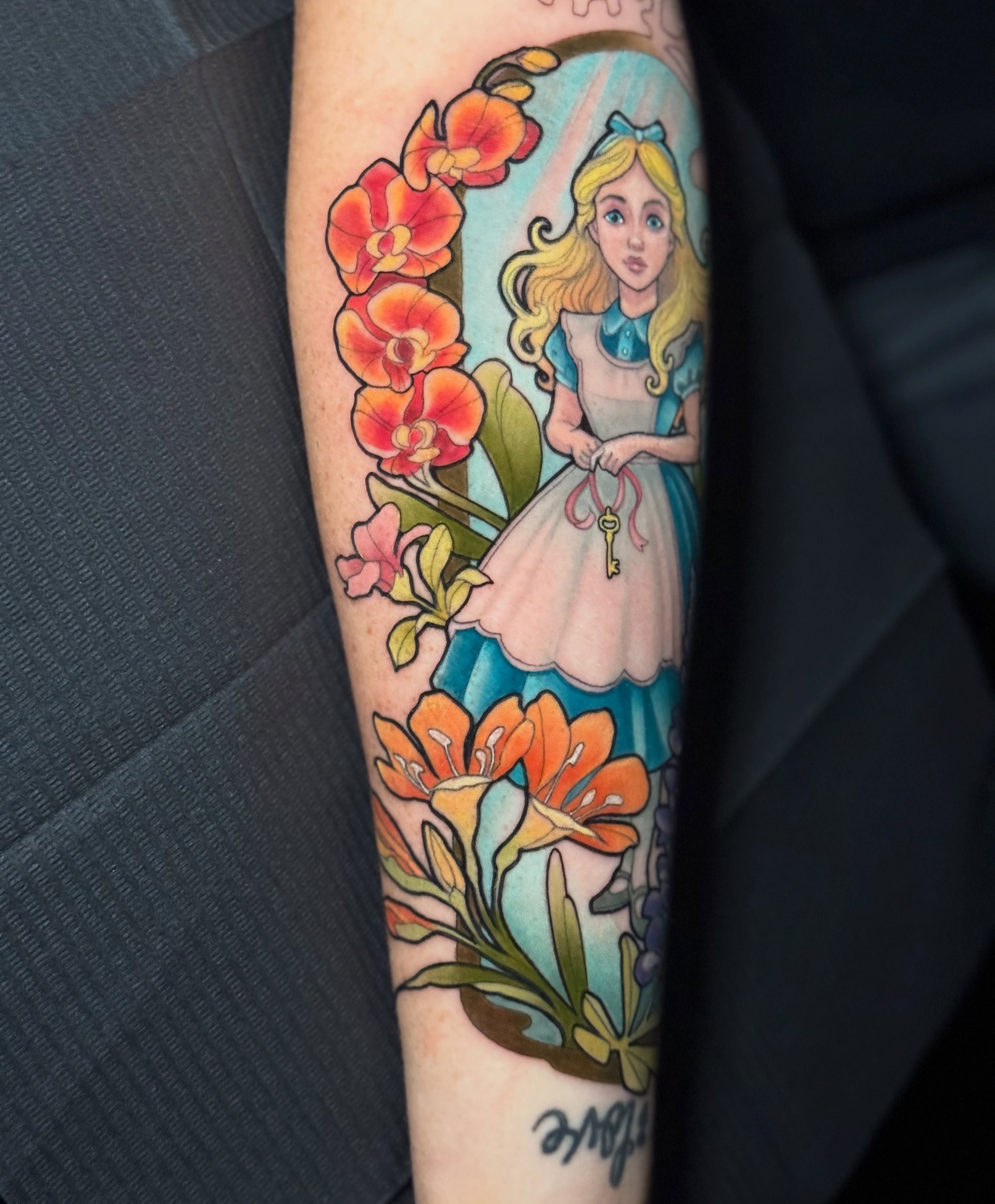 Alice in wonderland illustrative tattoo on the forearm by Steve Gentile Tattoos