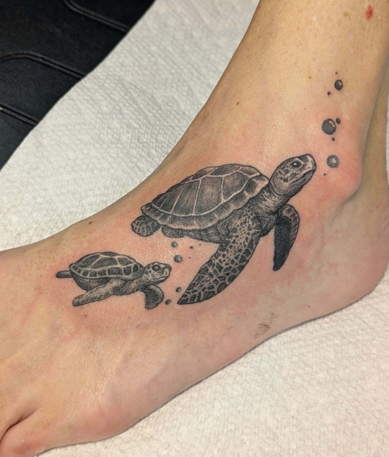 Sea turtles realism tattoo on the foot by Buddy K.