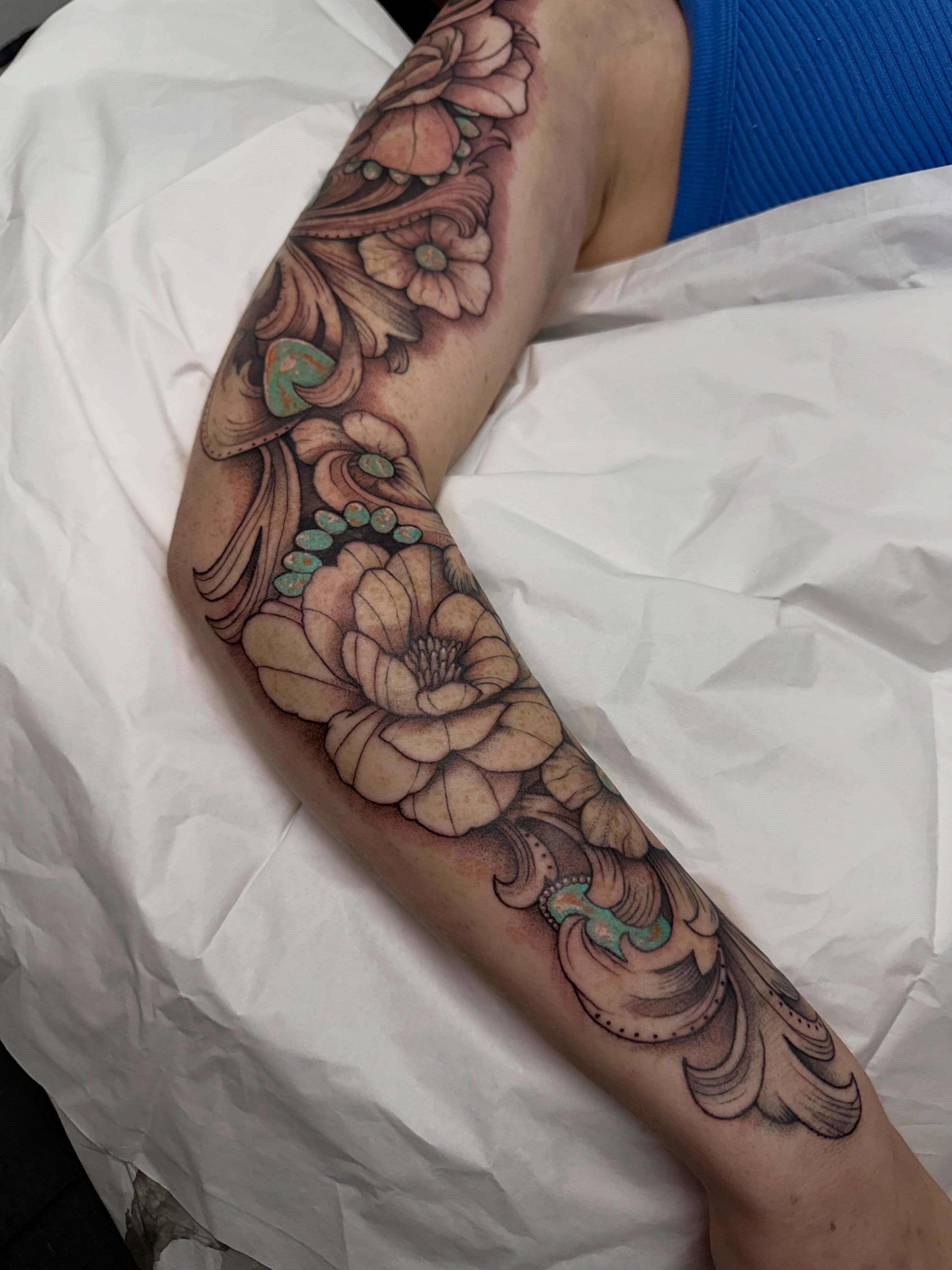 Floral bouquet American traditional tattoo on the forearm by Halle Cooper