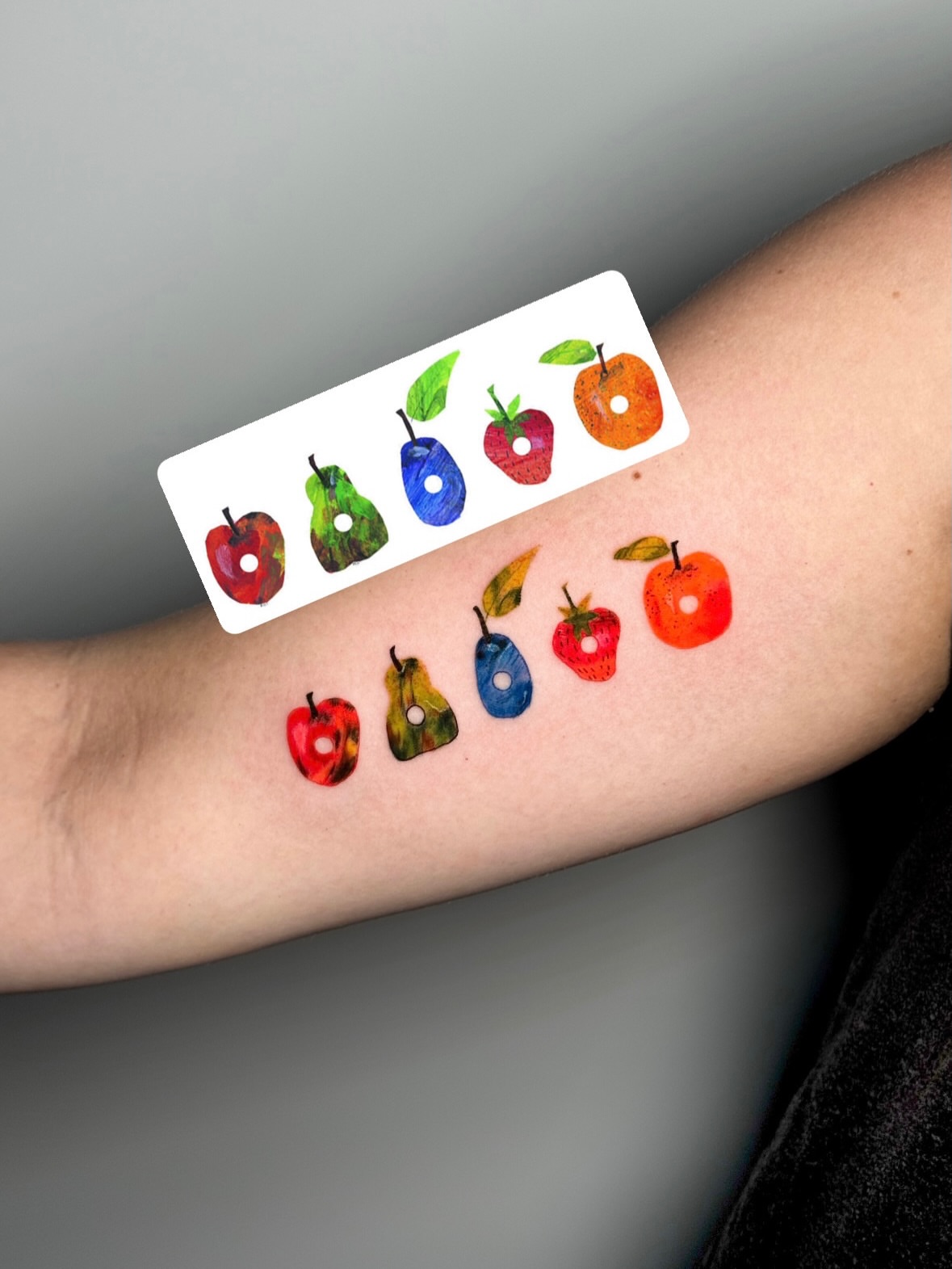 Fruits watercolor tattoo on the forearm by Luiny
