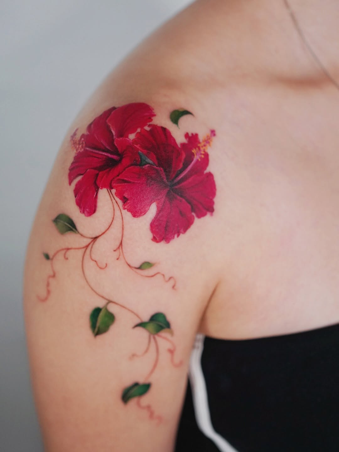 Hibiscus flowers and vines neo-traditional tattoo on the shoulder by Lily, Los Angeles, California