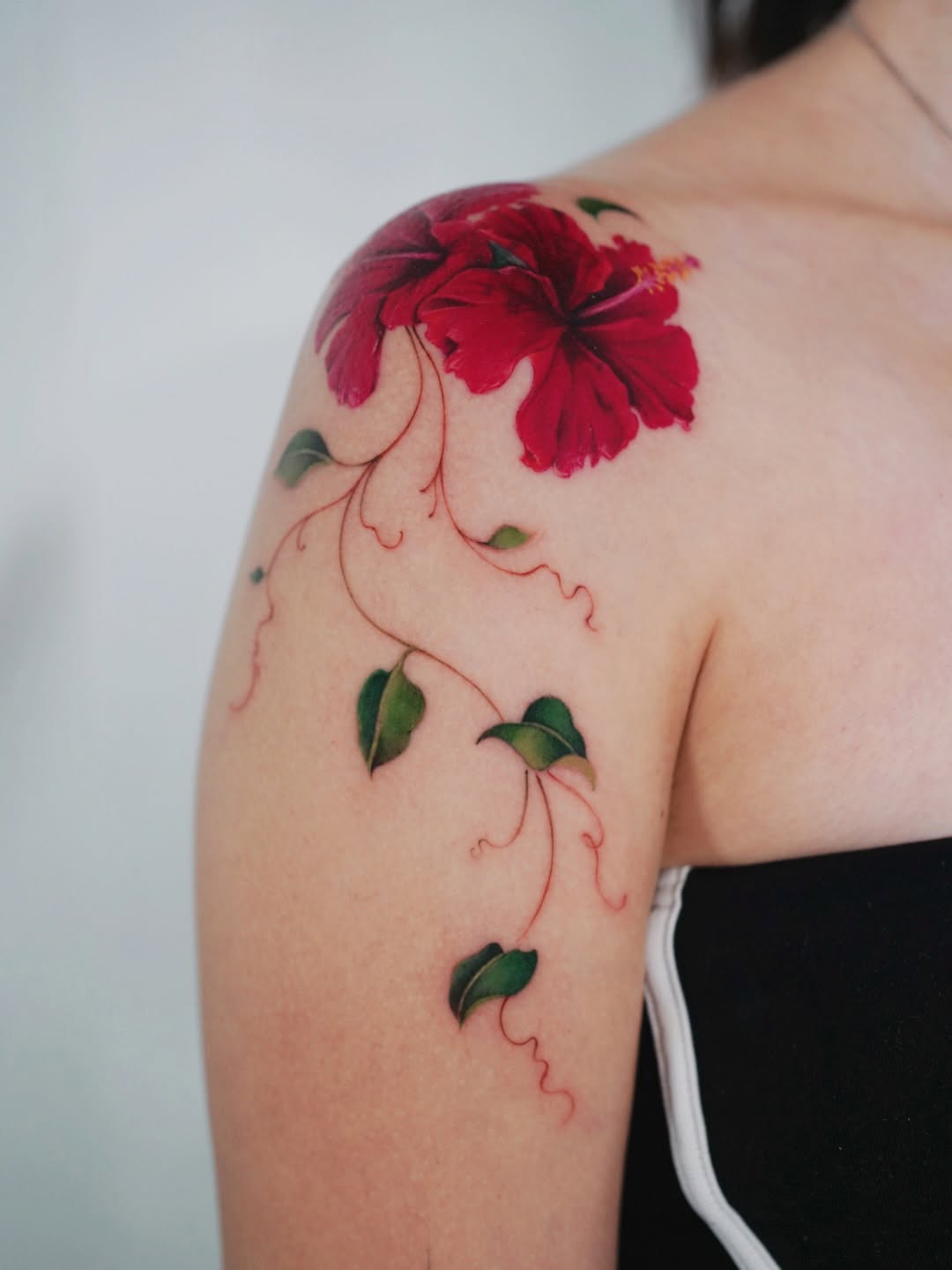 Hibiscus flower with vine neo-traditional tattoo on the shoulder by Lily, Los Angeles, California