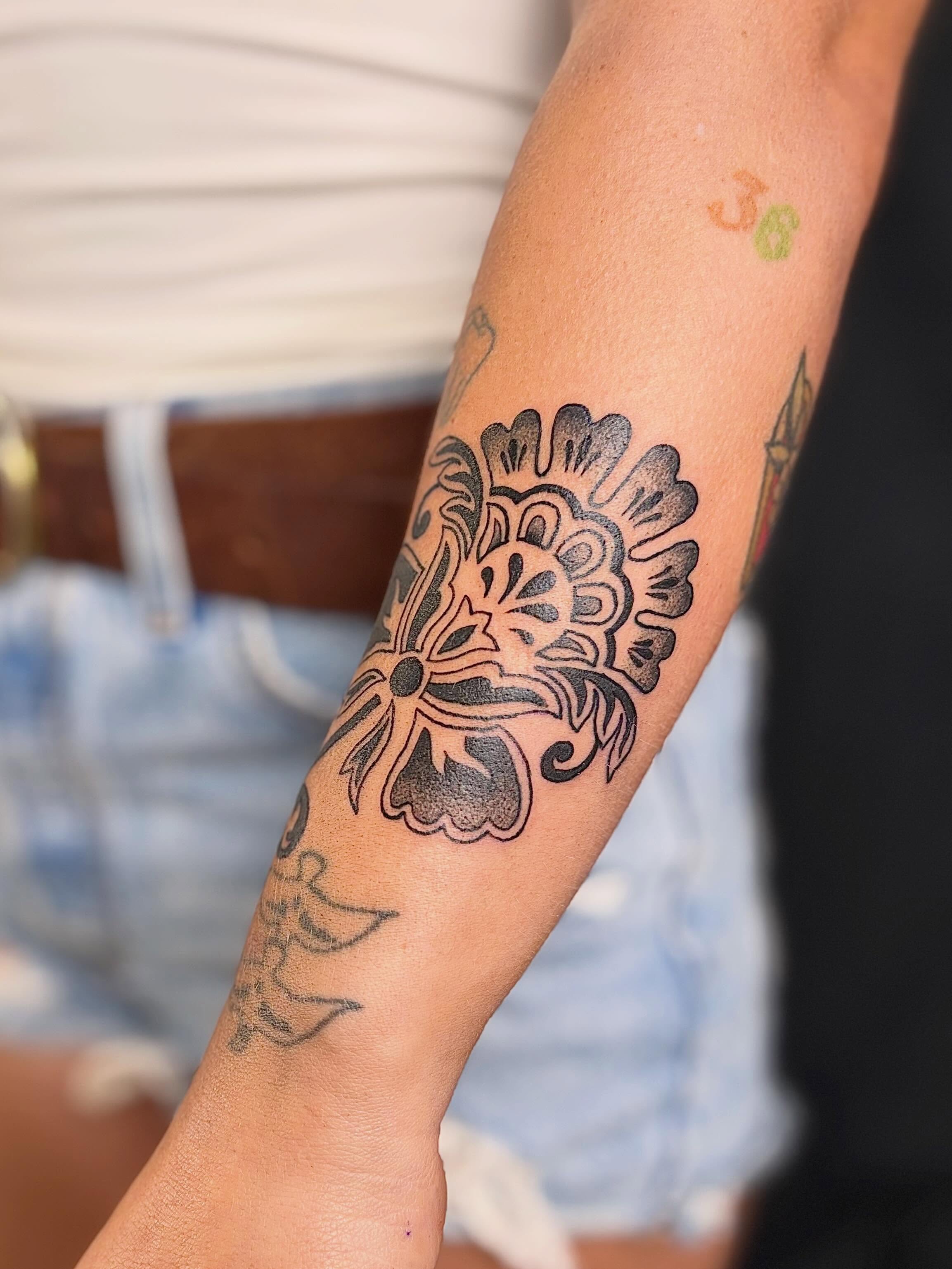 Floral design black and grey tattoo on the forearm by Erica McCullough