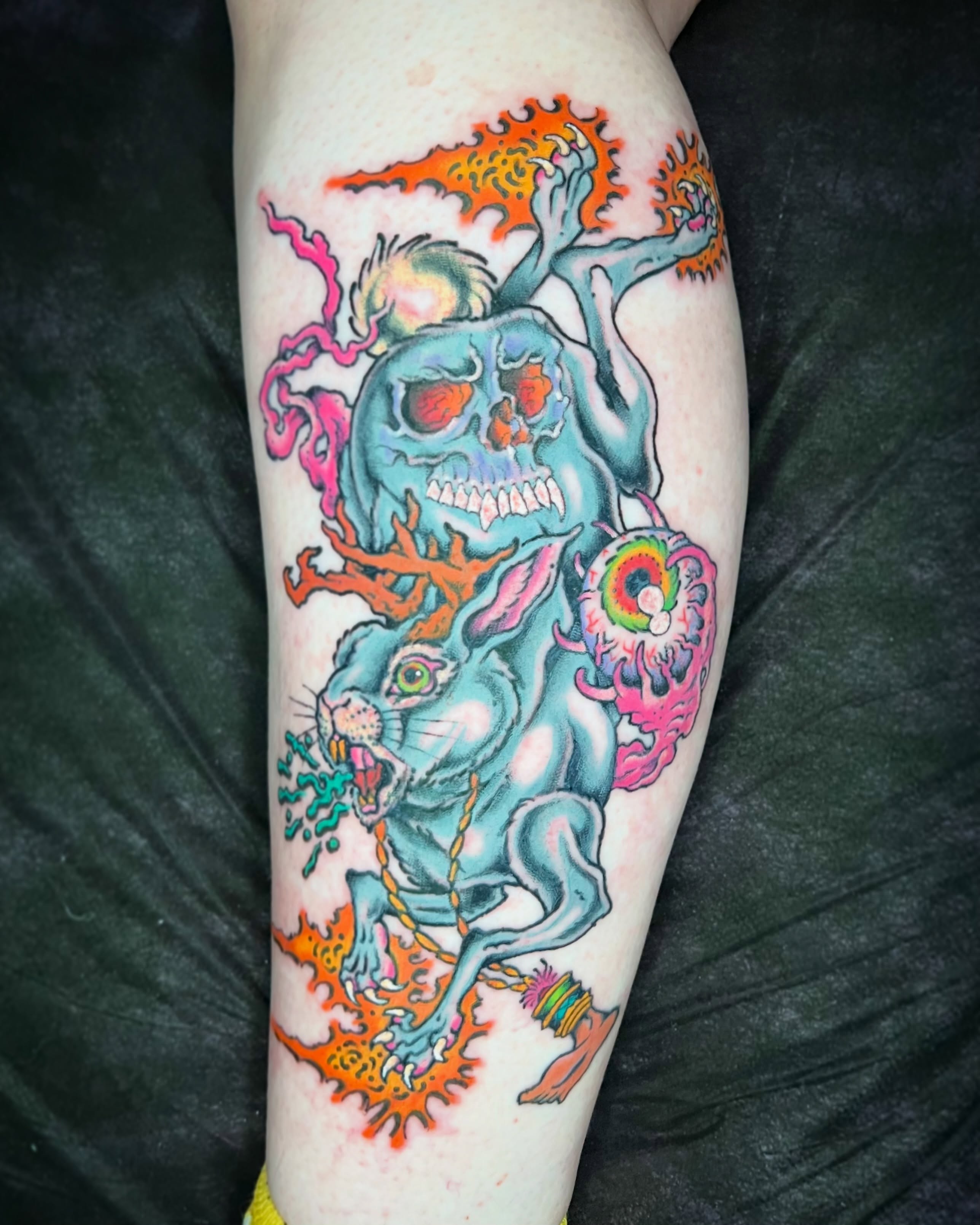 Skull and rabbit American traditional tattoo on the forearm by Jade Napier