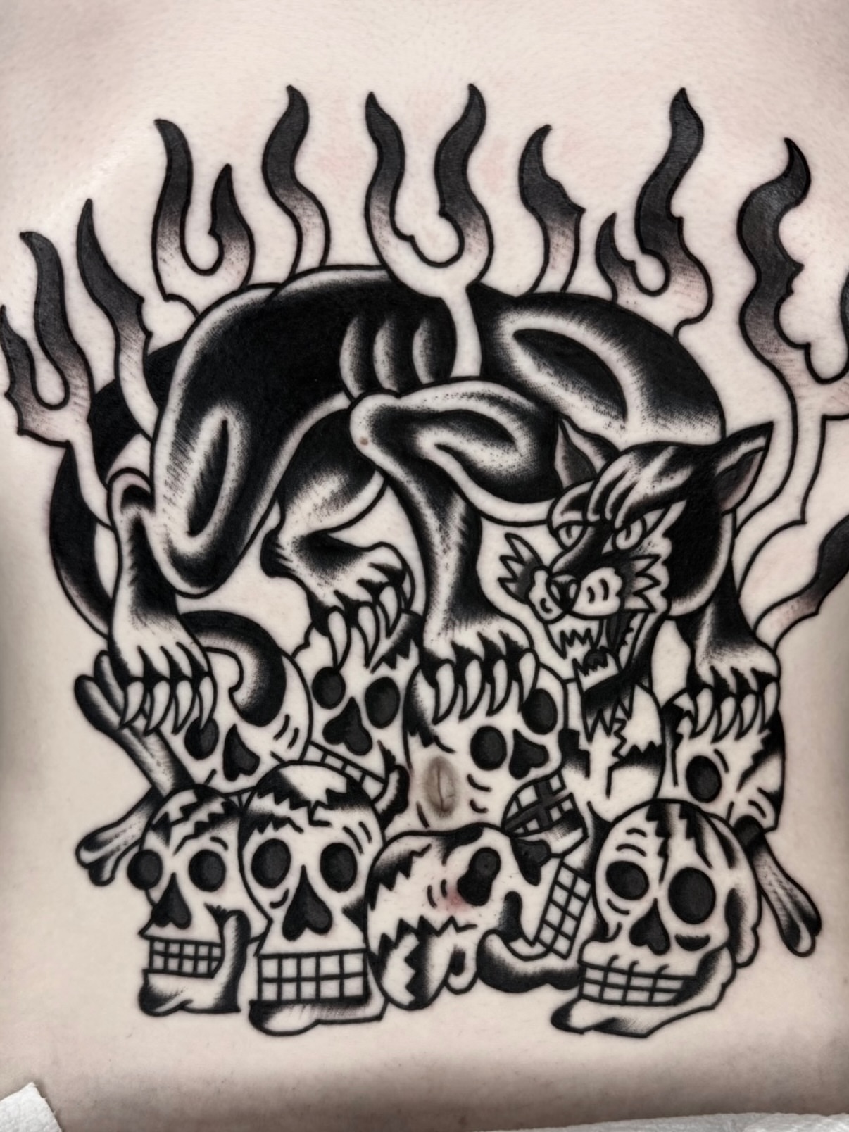 Skulls and flames American traditional tattoo on the torso by لا Kenny McCabe لا
