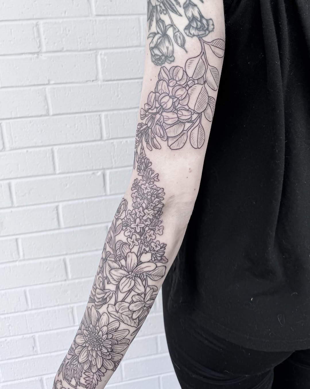 Floral bouquet black and grey tattoo on the forearm by Audrey Kacel, Holland, Michigan