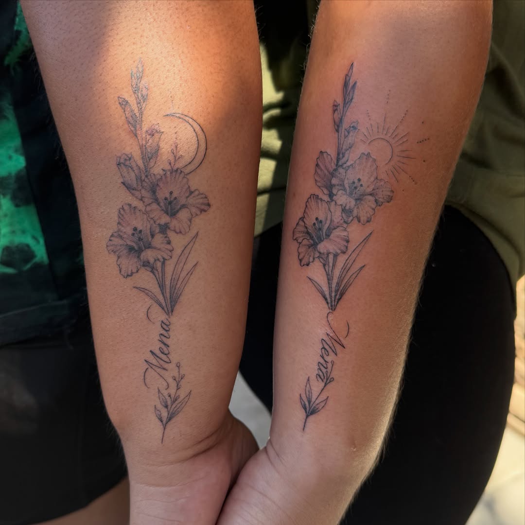 Gladiolus flowers black and grey tattoo on the forearm by Faith Lopez