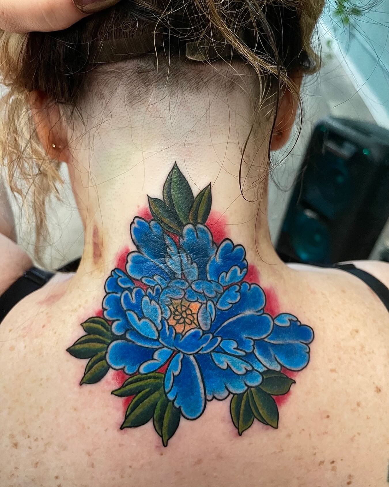 Blue peony American traditional tattoo on the neck by Nicholas Misitano