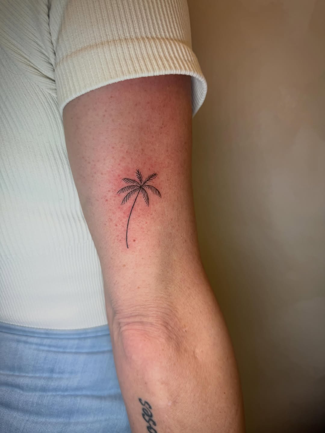 Palm tree lettering tattoo on the forearm by Danny Garcia