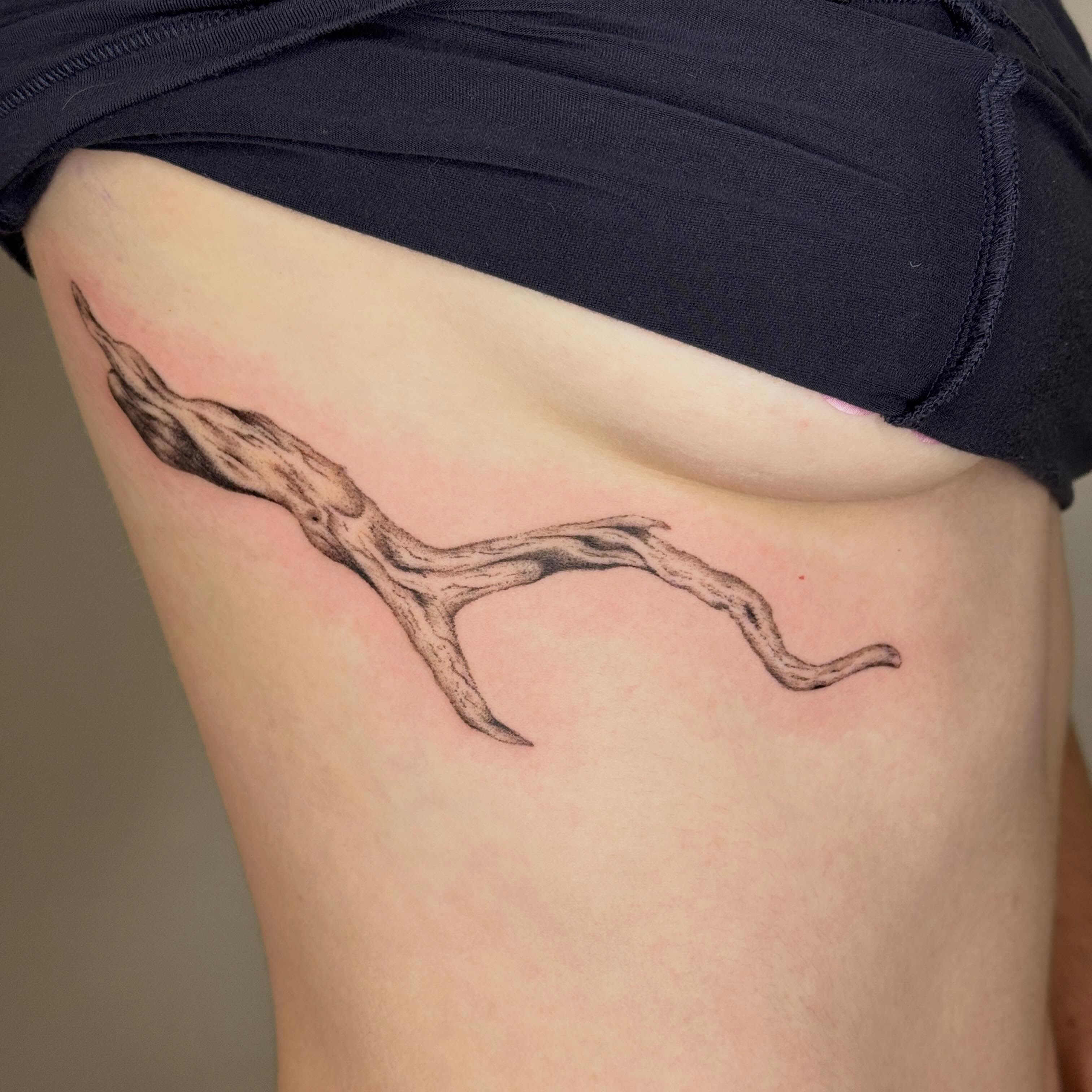 Branch black and grey tattoo on the thigh by Monica Reynolds