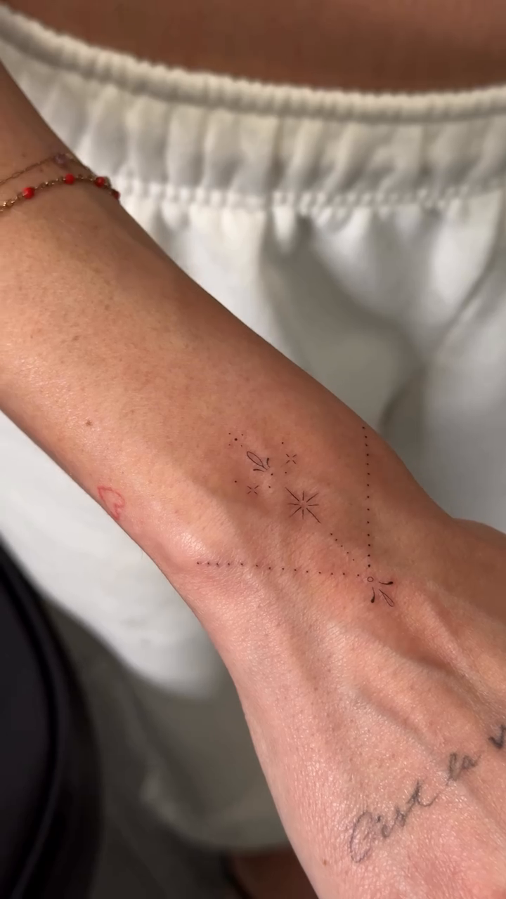 Delicate floral design with script text minimalist tattoo on the forearm by Jennifer Garcia R - Vegas tattoo artist