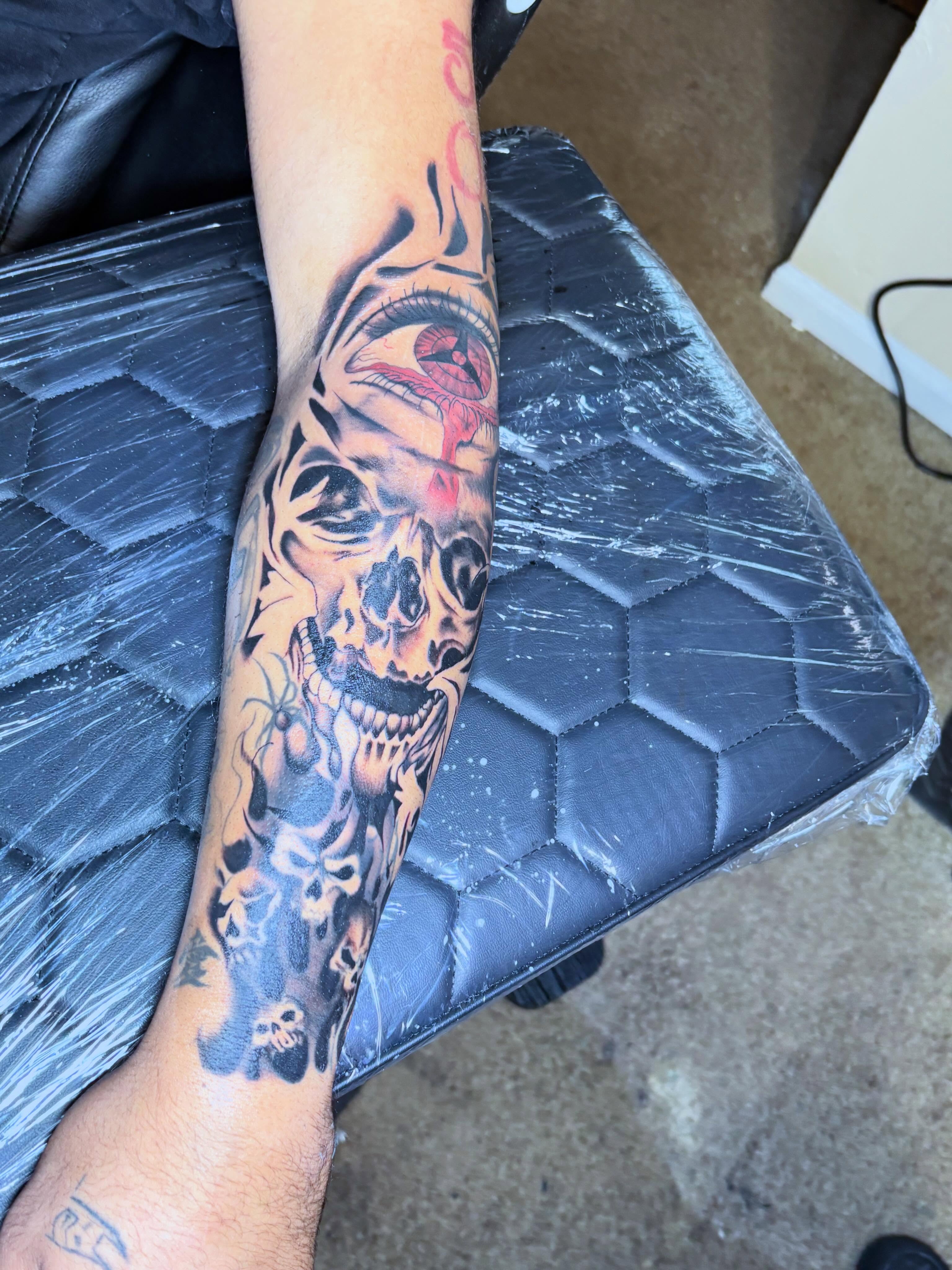 Skull and eye dark realism tattoo on the forearm by Mr.K