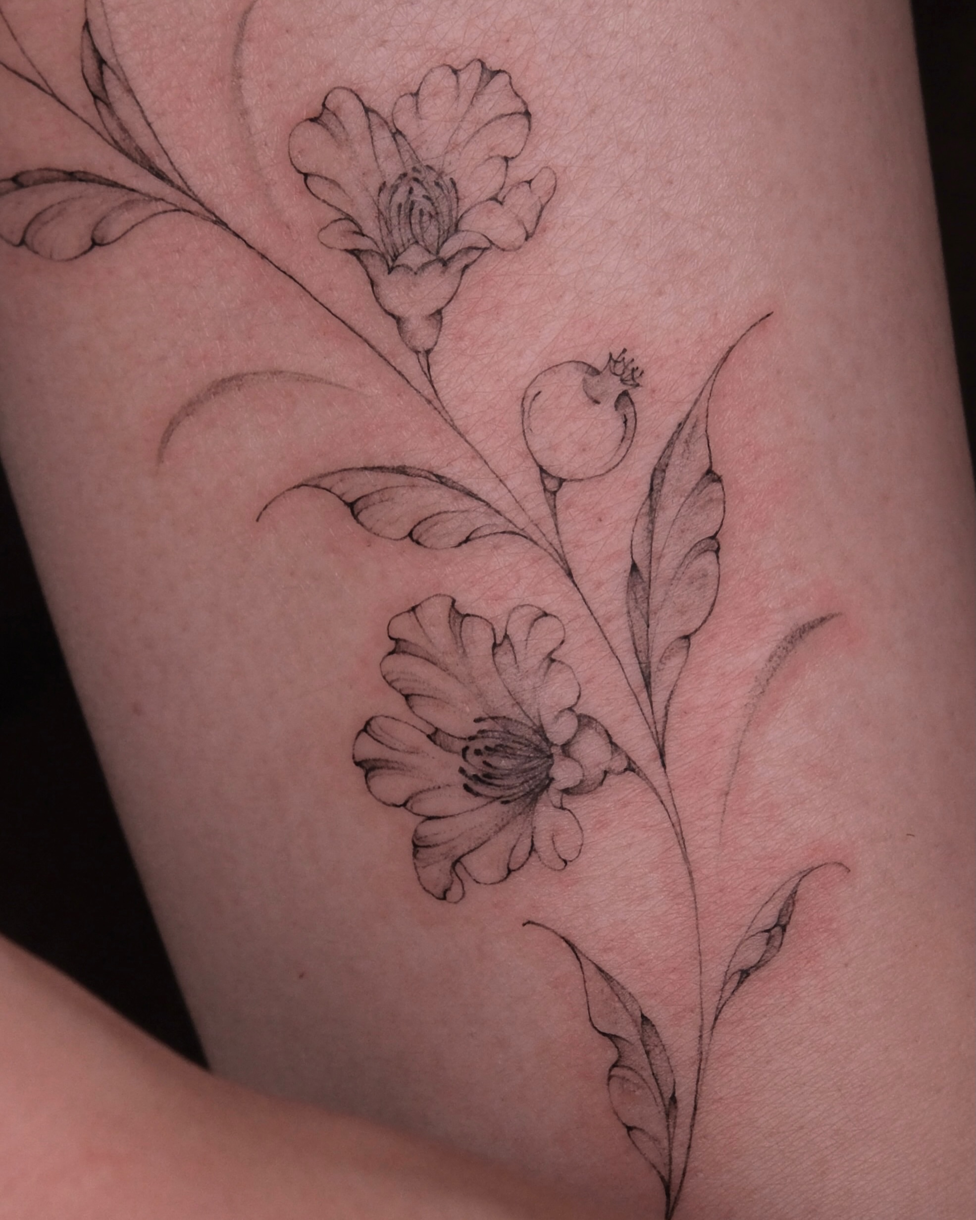Floral arrangement black and grey tattoo on the forearm by Göksu