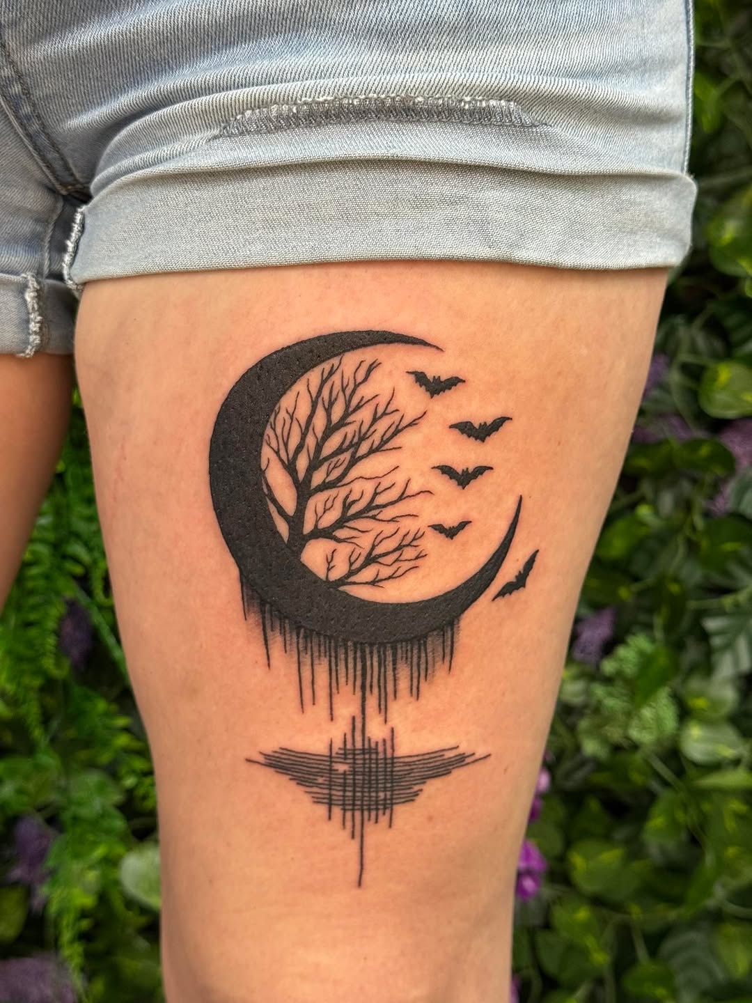 Crescent moon with tree and bats fine line tattoo on the thigh by Sabrina