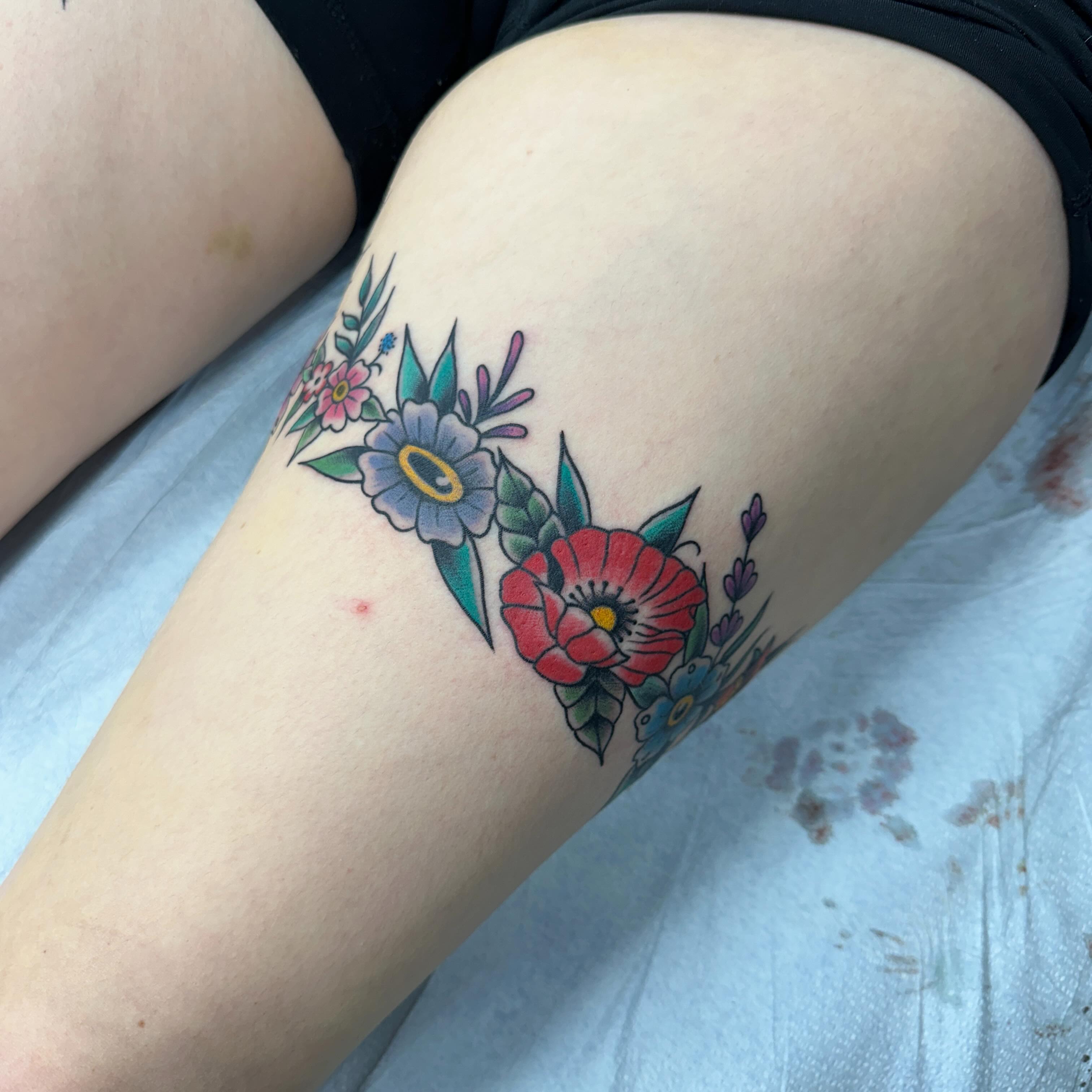 Floral bouquet new school tattoo on the thigh by Fil Ponte