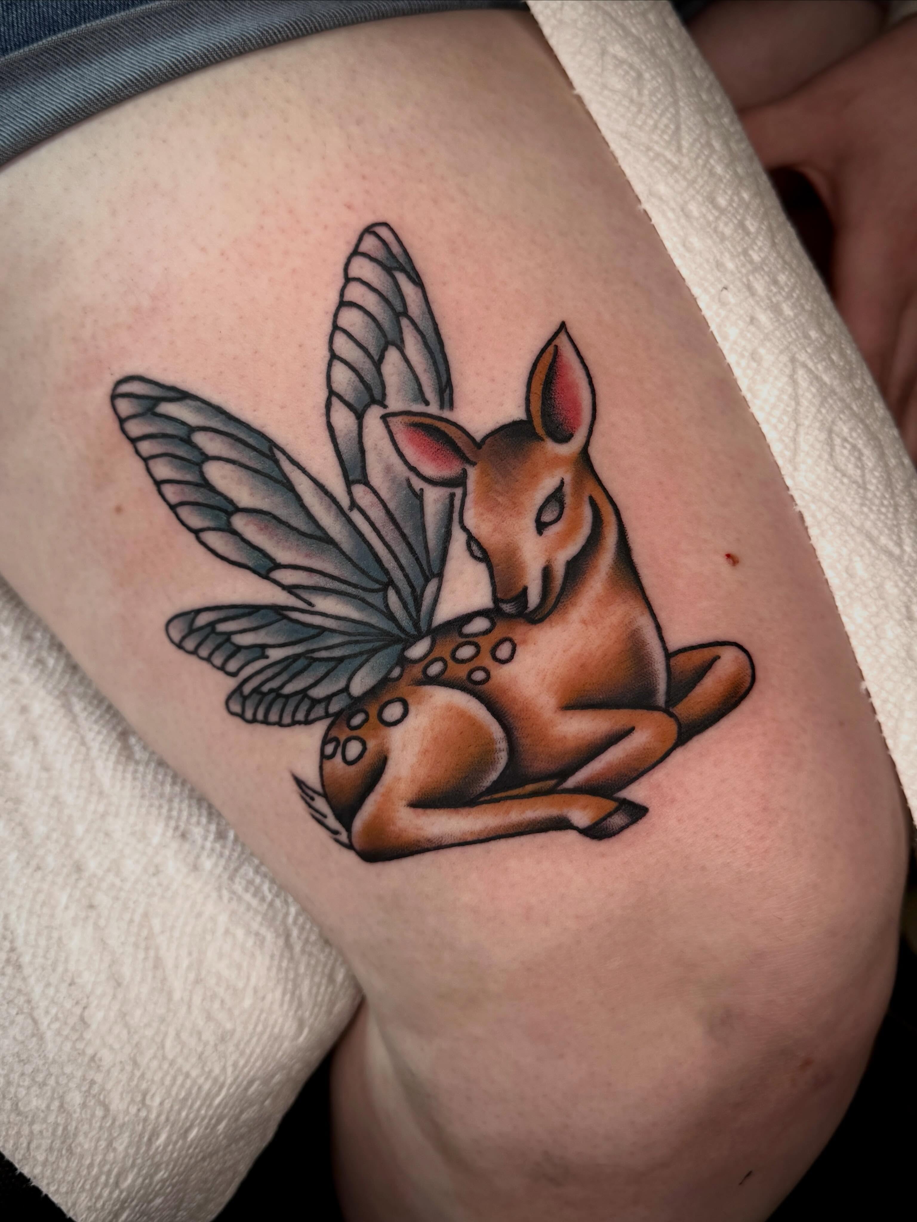 Fawn with wings American traditional tattoo on the thigh by Meg Nefcy, Milford, Michigan