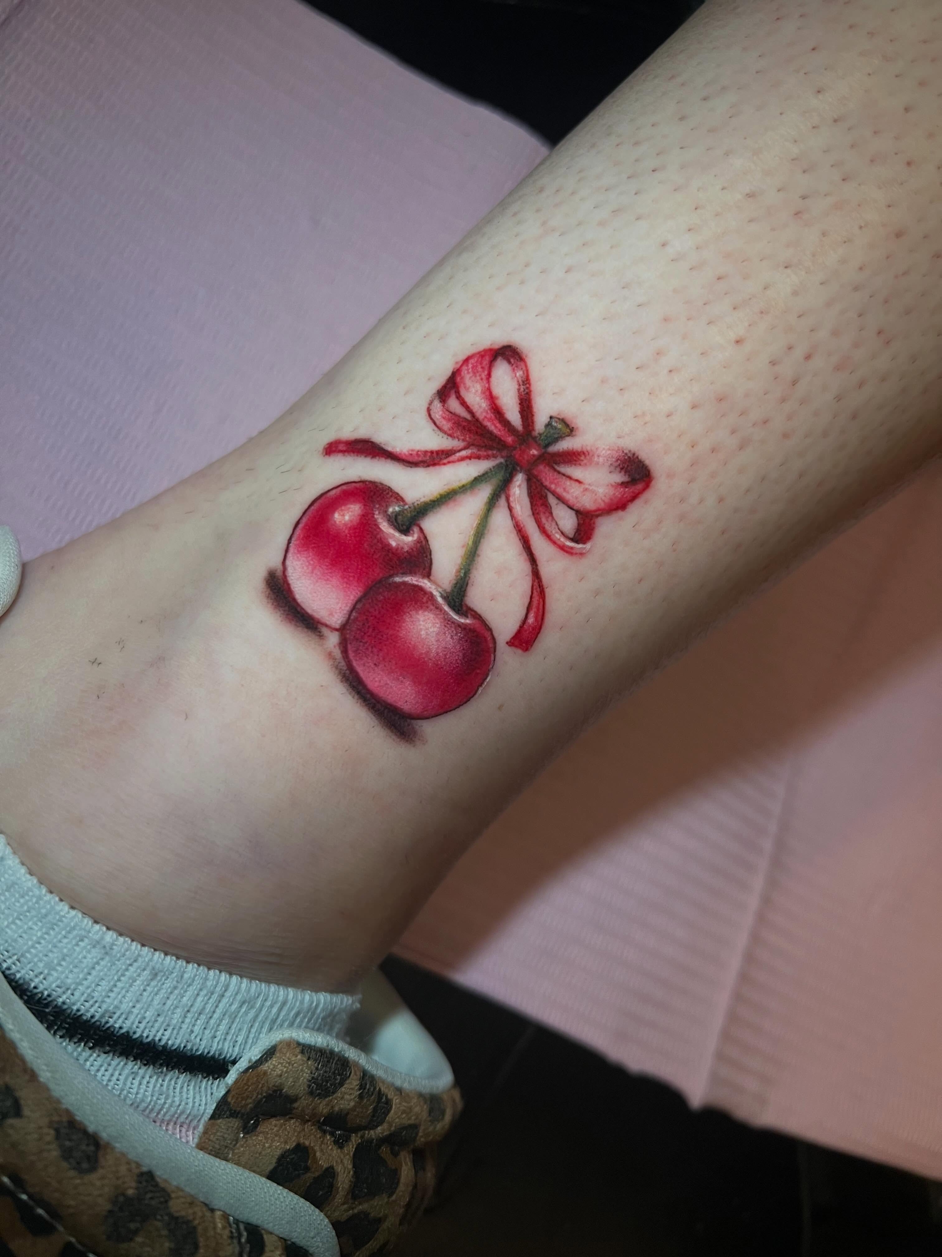 Cherries realism tattoo on the forearm by jessica valentine