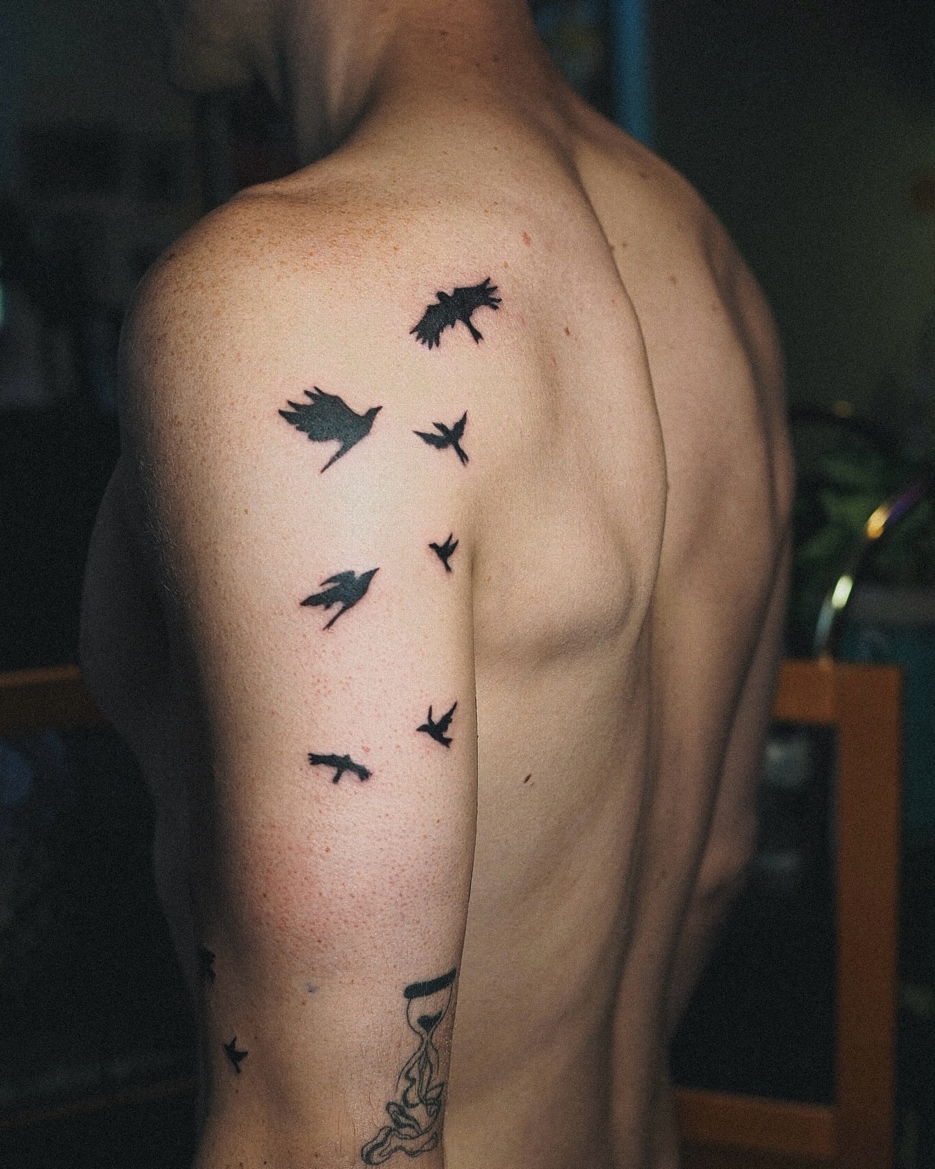 Birds in flight black and grey tattoo on the shoulder by Inks by Nastia