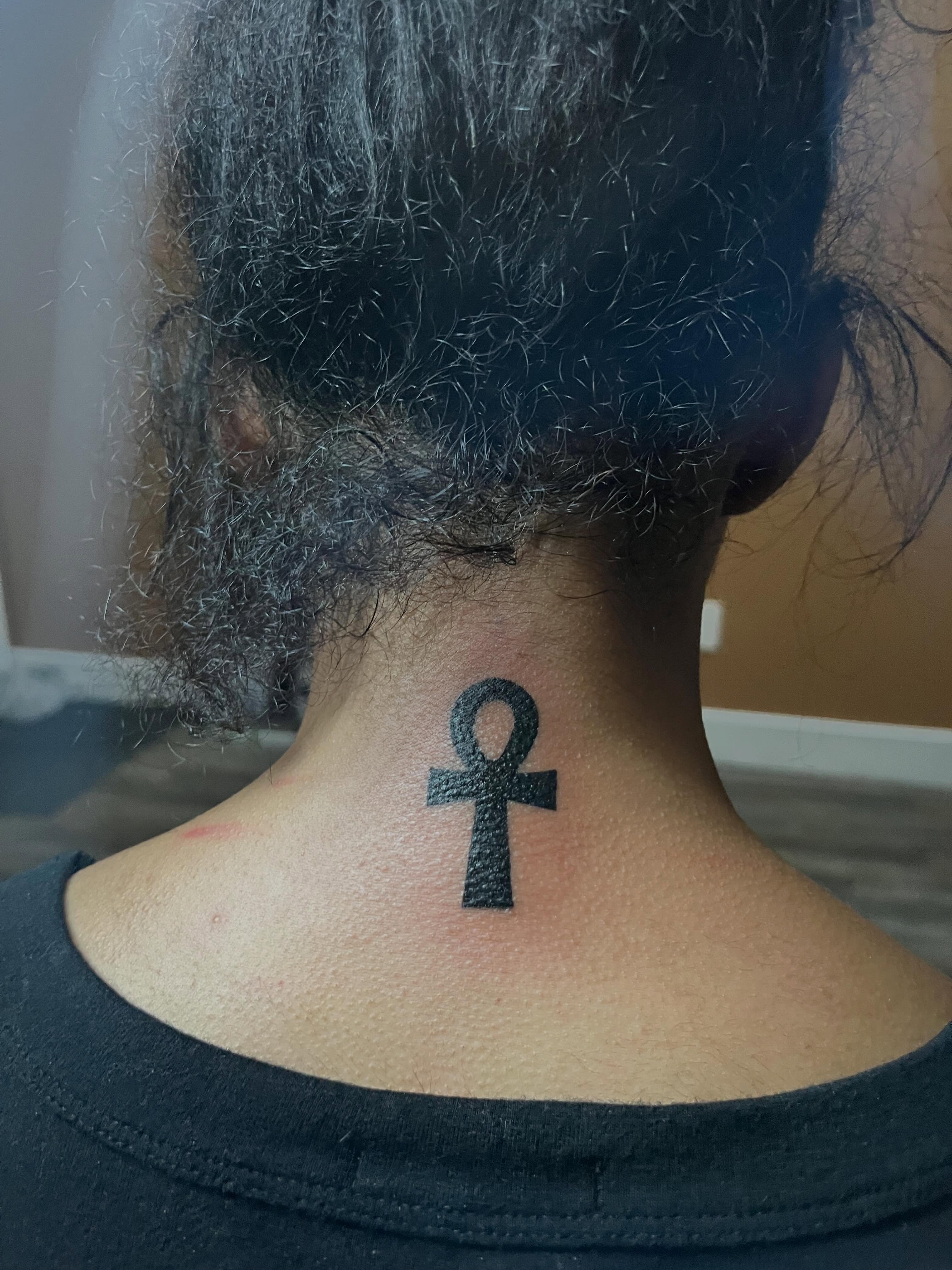 Ankh symbol black and grey tattoo on the neck by Tam💟👩🏽‍🎨