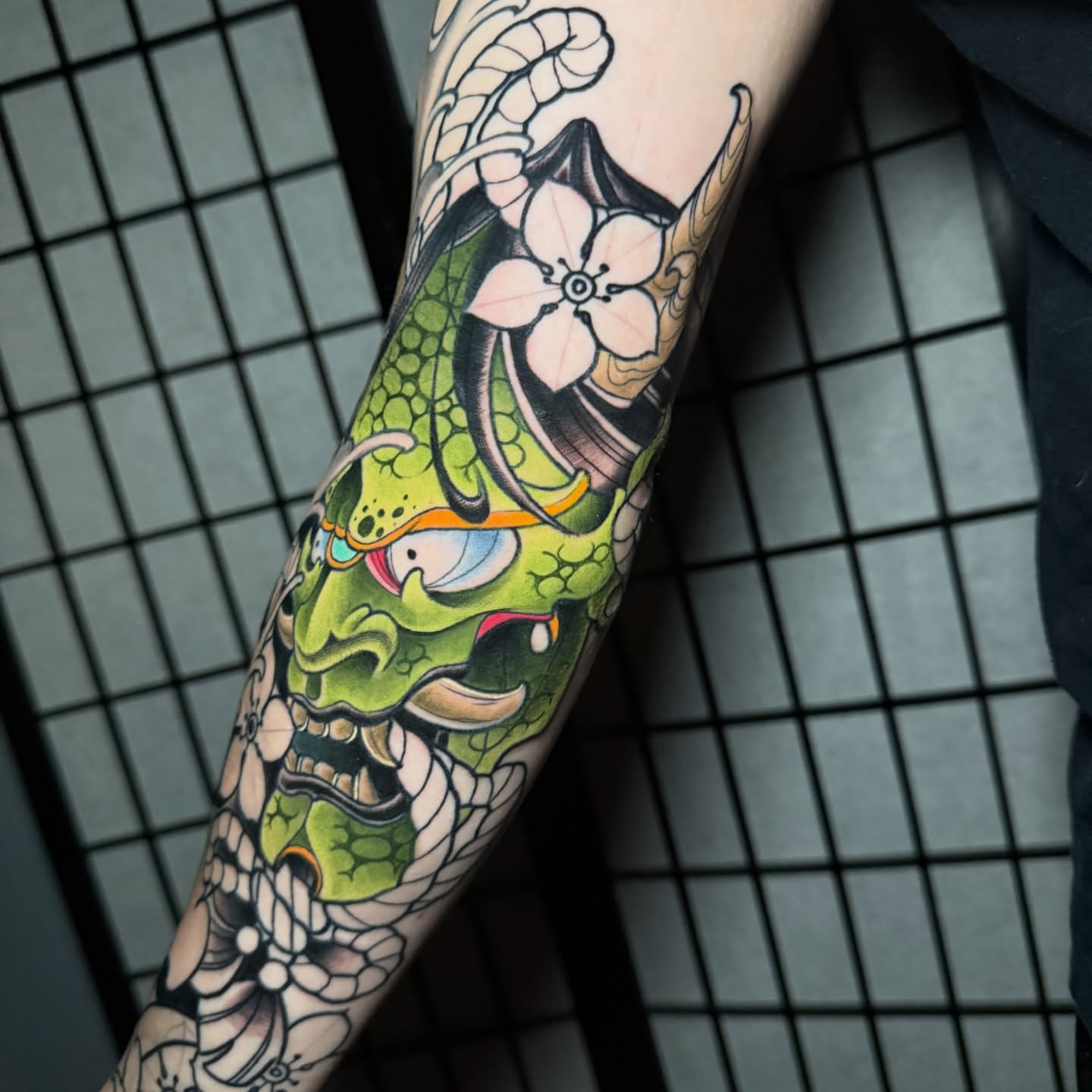 Monster and flower japanese irezumi tattoo on the forearm by taylor mills