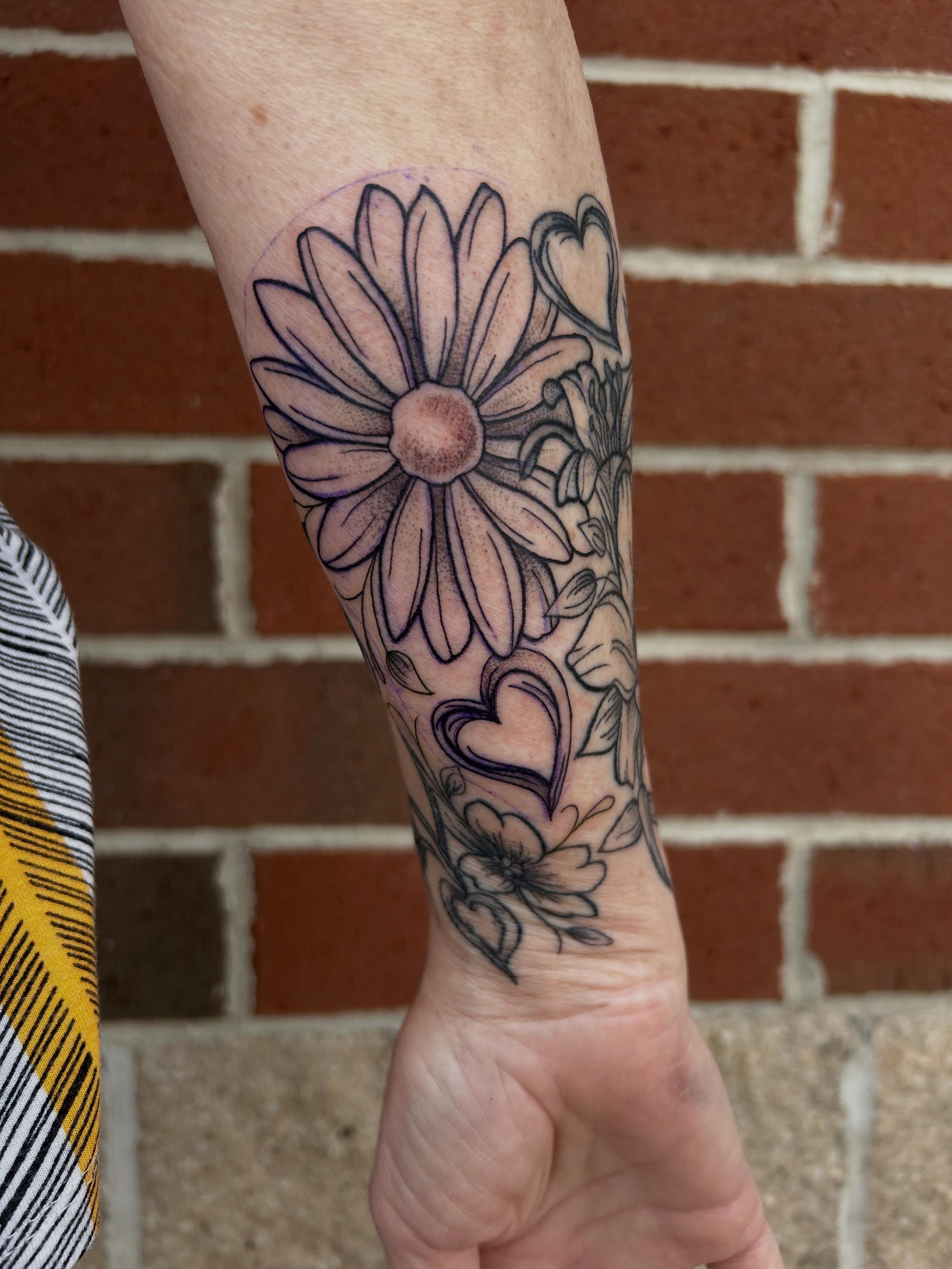 Flower and hearts black and grey tattoo on the forearm by Cassidy Hammer, Westland, Michigan
