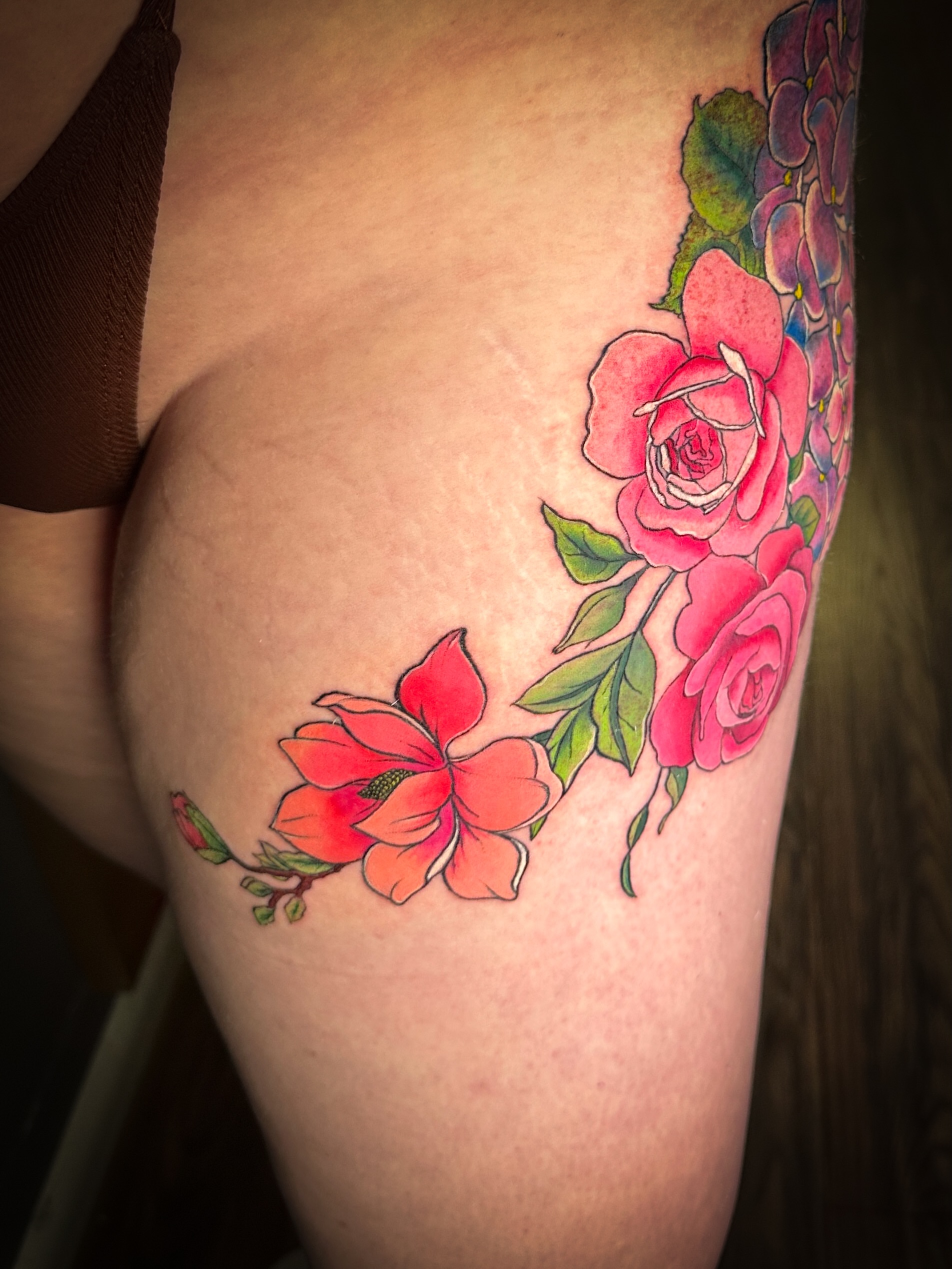 Flowers watercolor tattoo on the thigh by Jennifer Ramirez