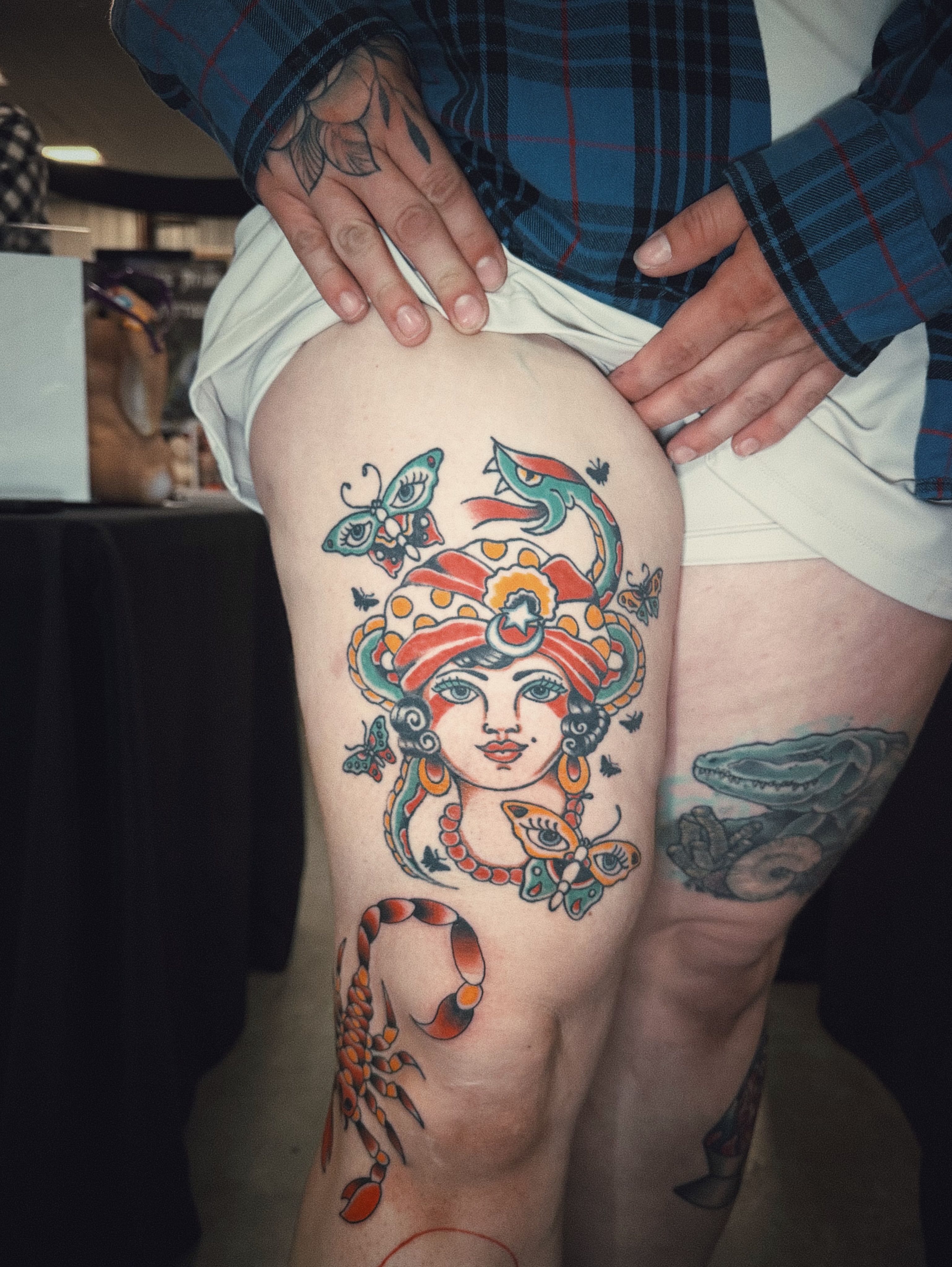 Woman with snake American traditional tattoo on the thigh by Dustie Pitstick
